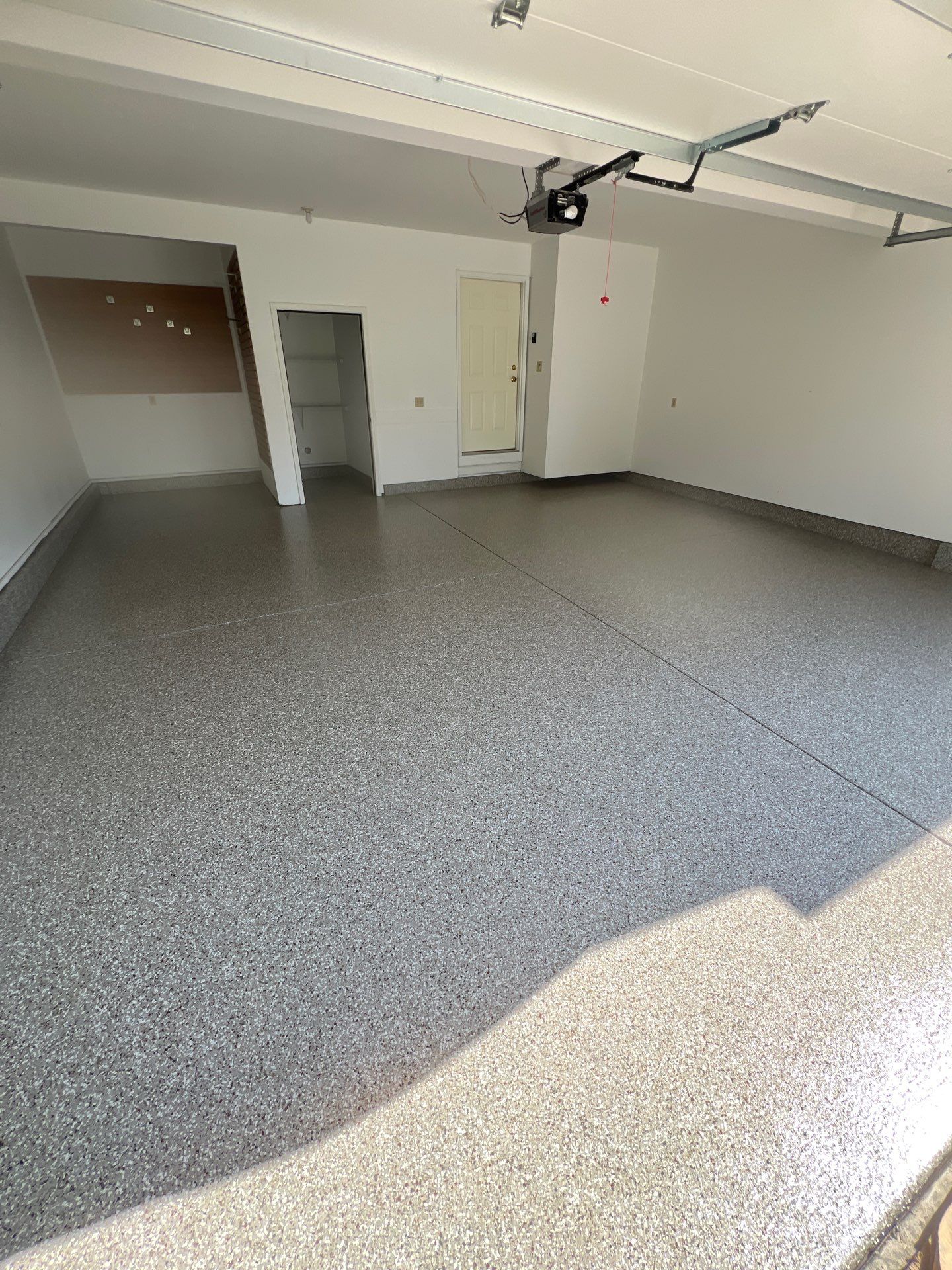 Garage floor in Holt using Smoke Flake by Freedom Concrete Coatings. 