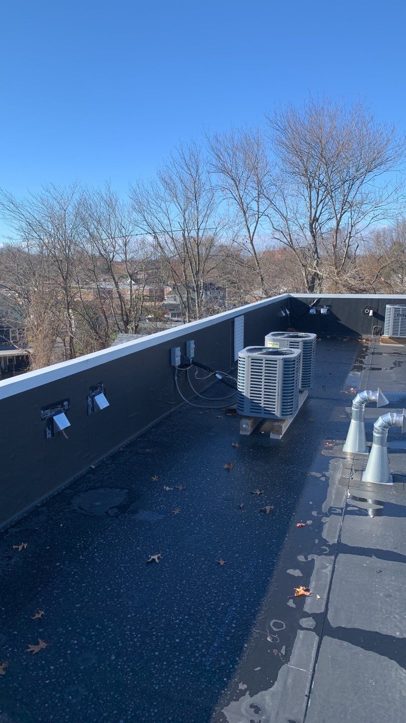 Commercial Roofing Installation using EPDM with white gutters by A Plus Exterior