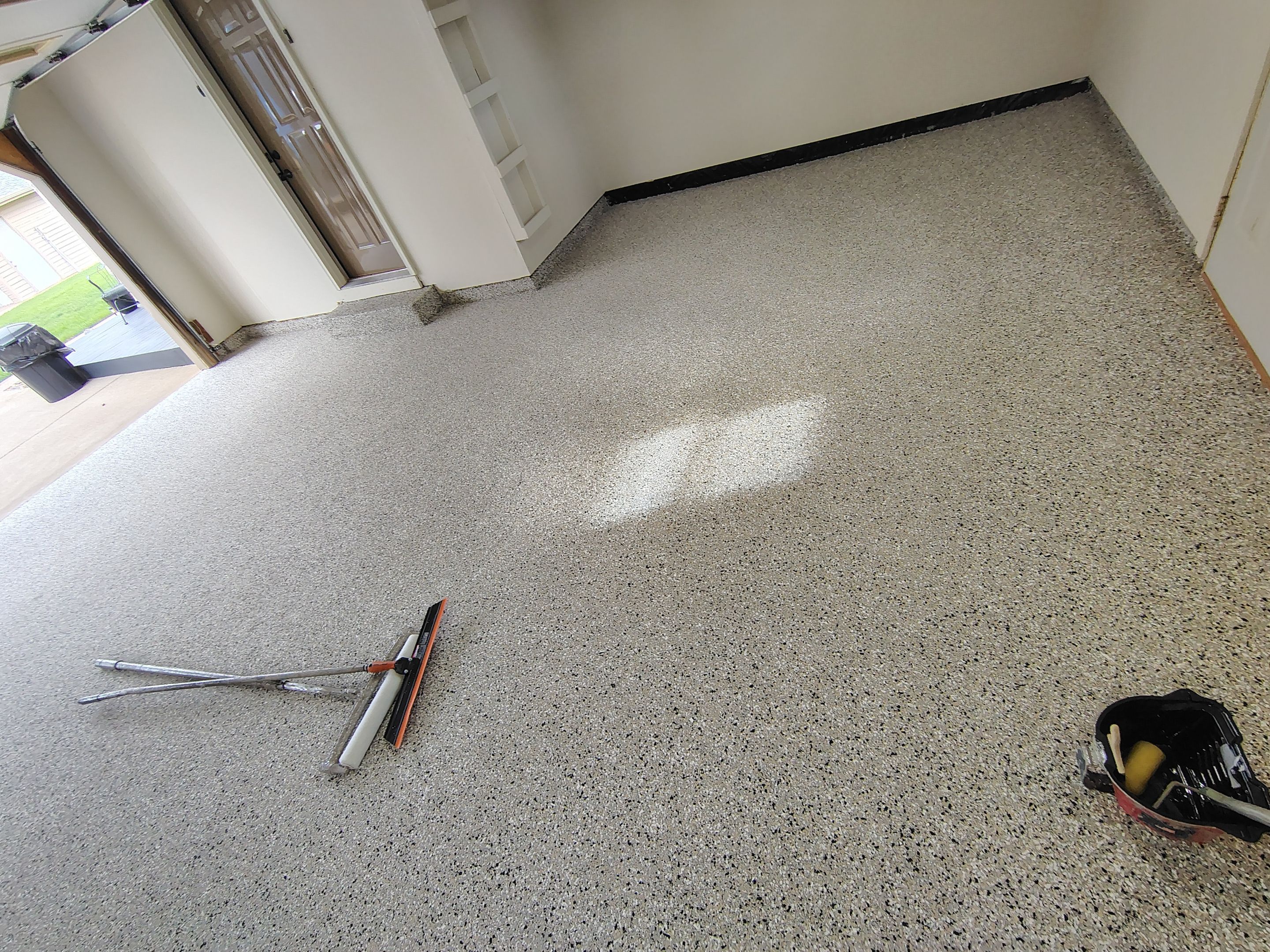 Full-Flake Epoxy Garage Floor Coating Installation in Sioux Falls by Select Painting, Coatings & Garage Cabinets