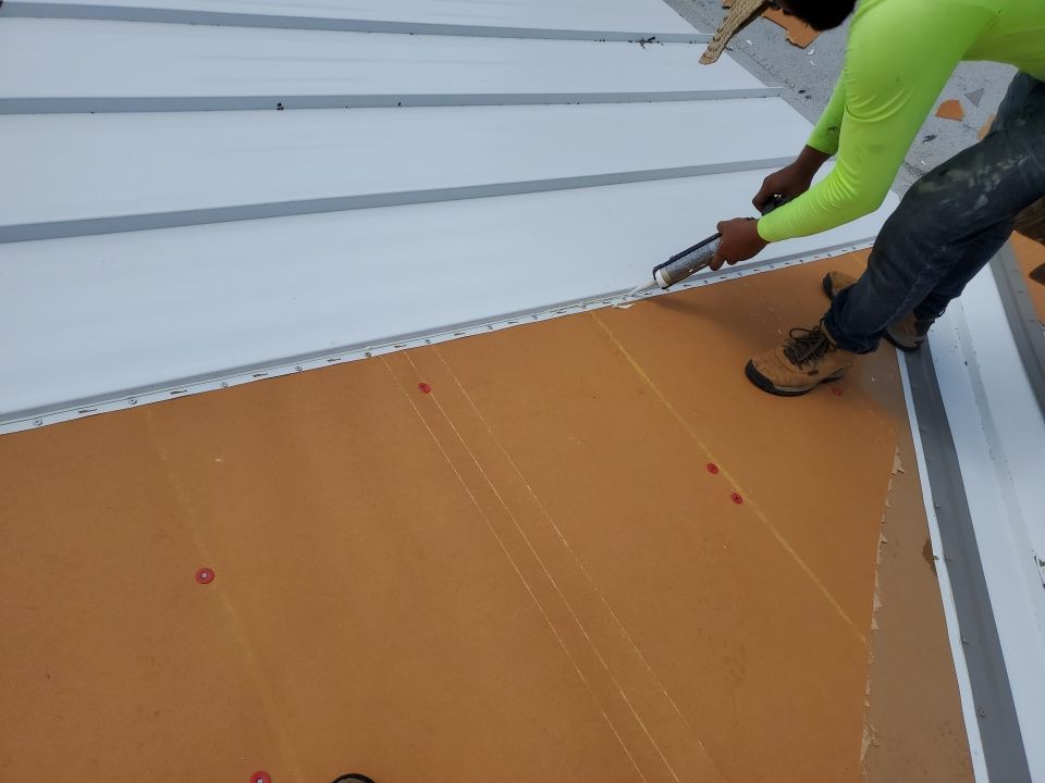 Residential Roofing Installation using 1.5" Nail Strip 24ga Solar White Kynar Coated Standing Seam Metal Panels by Morton Roofing, Inc.
