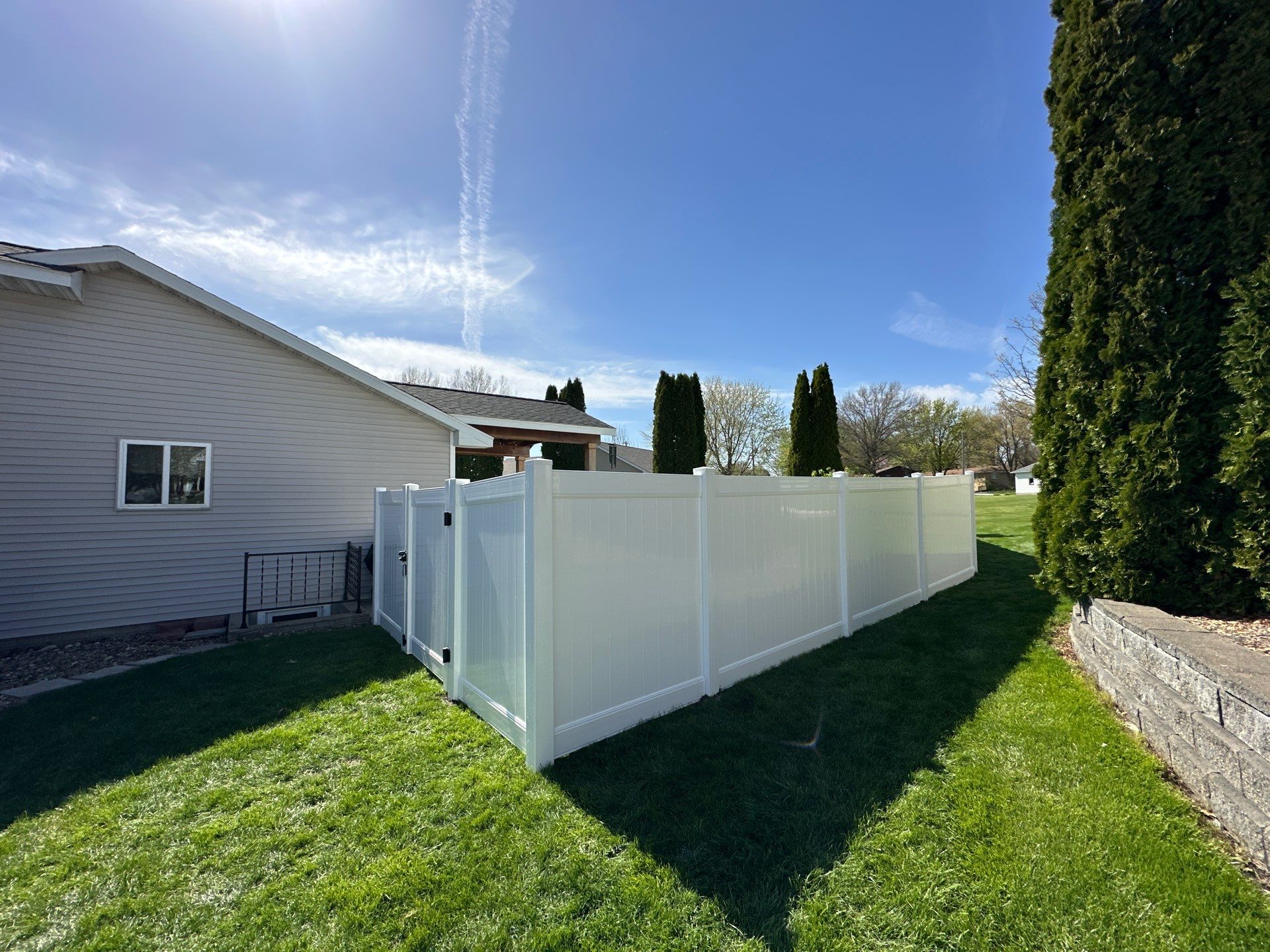 White Vinyl Privacy Fence Installation in Raymond, Iowa by Perfect Picket Fence and Stain