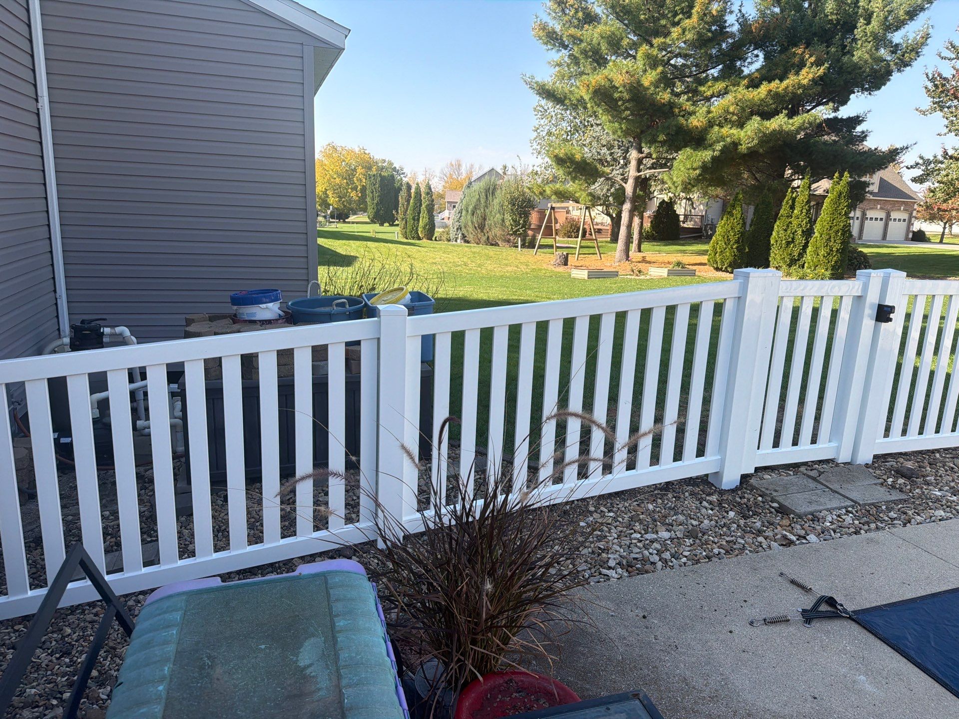 White Vinyl Picket Pool Fence Installation in Waterloo, Iowa by Perfect Picket Fence and Stain