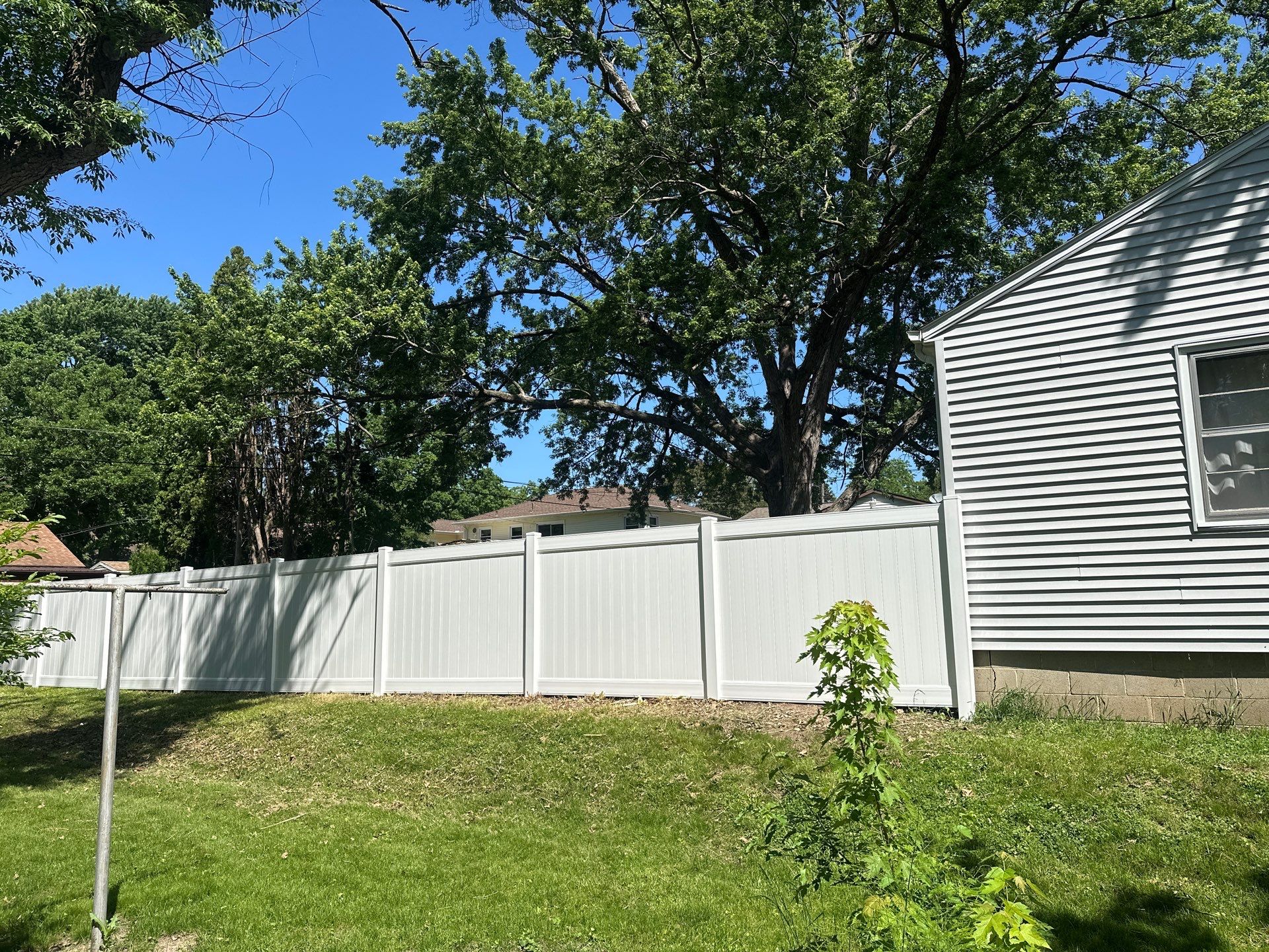 White Vinyl Privacy Fence and Double Gate Installation in Cedar Falls by Perfect Picket Fence and Stain