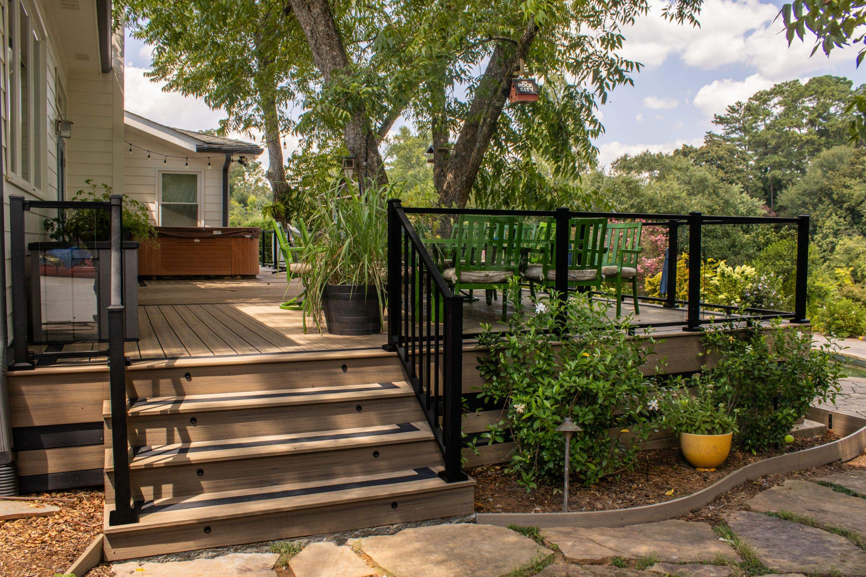 Deck Resurface with Glass Paneling and Deckorators Voyage Series Products by Nelson Exteriors 