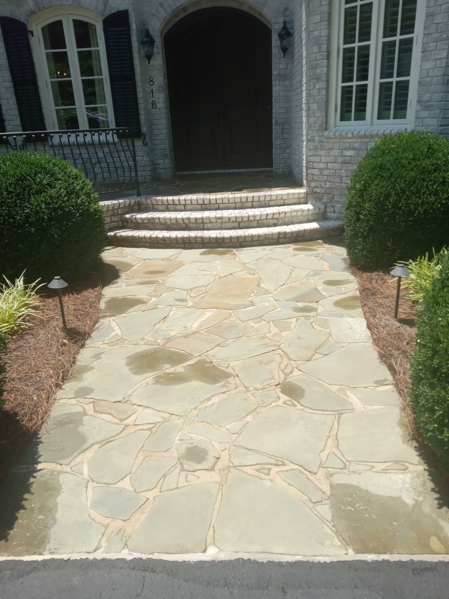 pressure washing flagstone walkway and steps removing dirt and stains restoring appearance