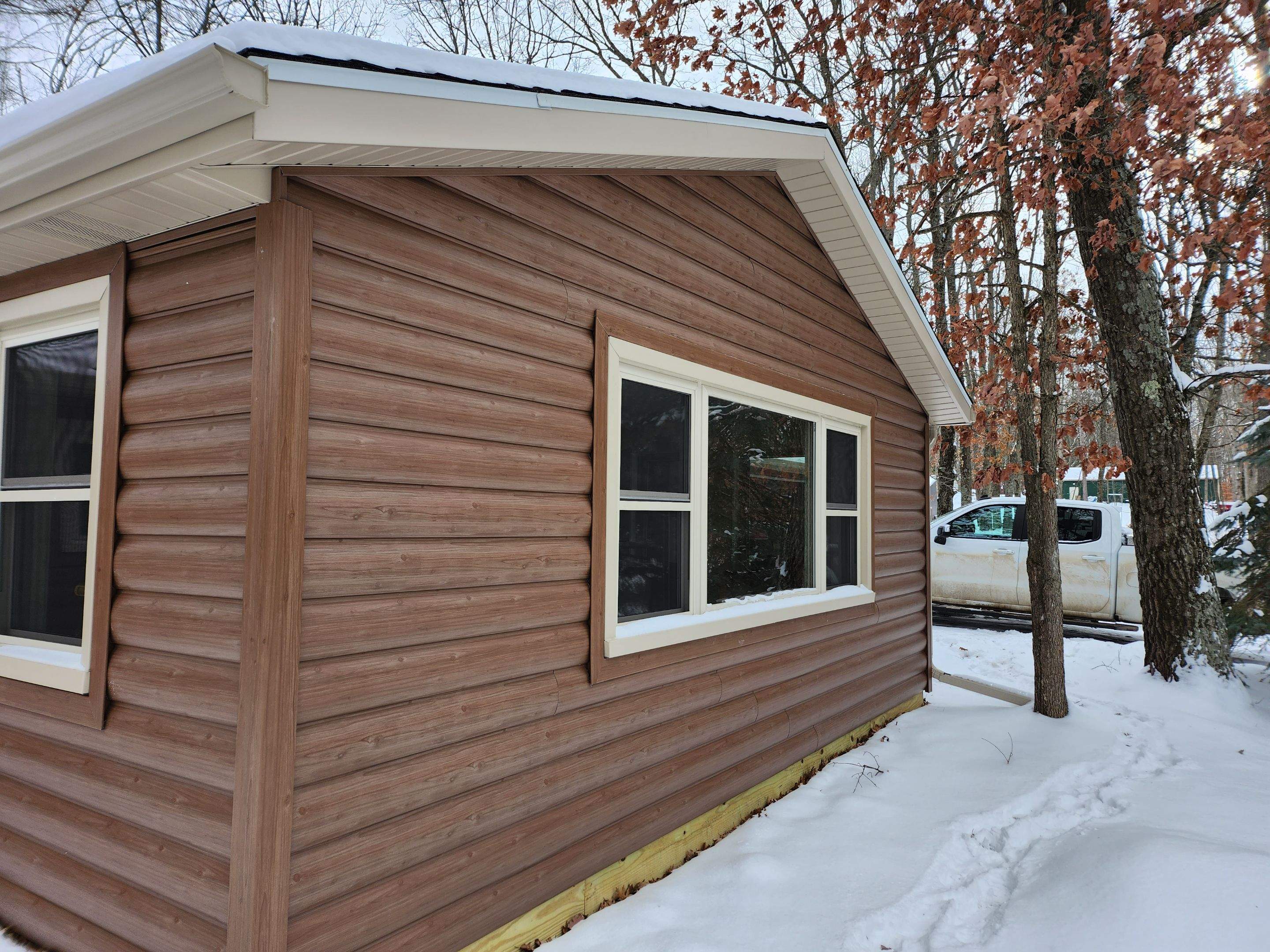 New addition and log siding by Energy Plus Home Improvements