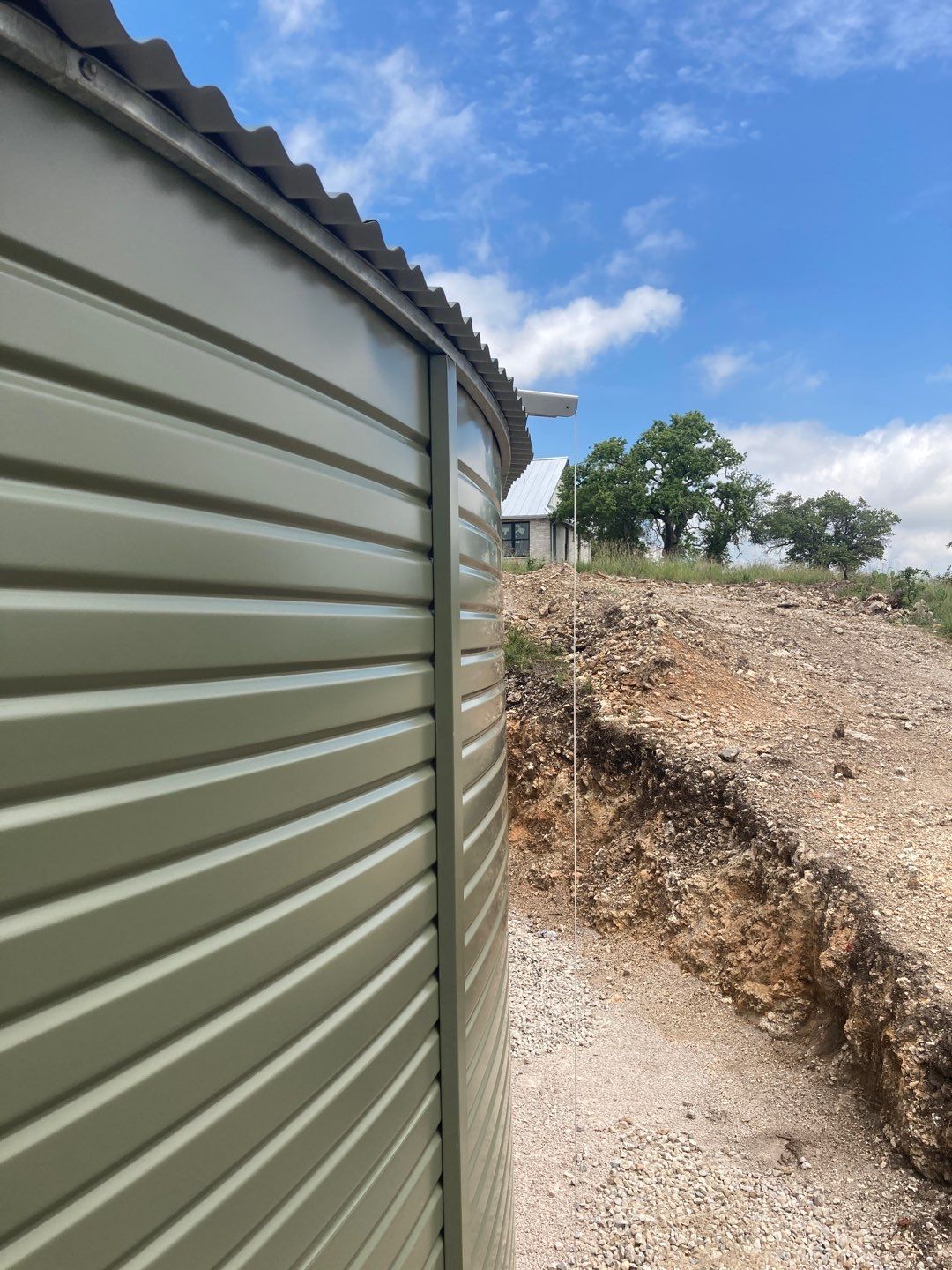 Residential Rainwater Collection System - Pioneer 40K gallon water tank in Mangrove Green by Hill Country Rain Water