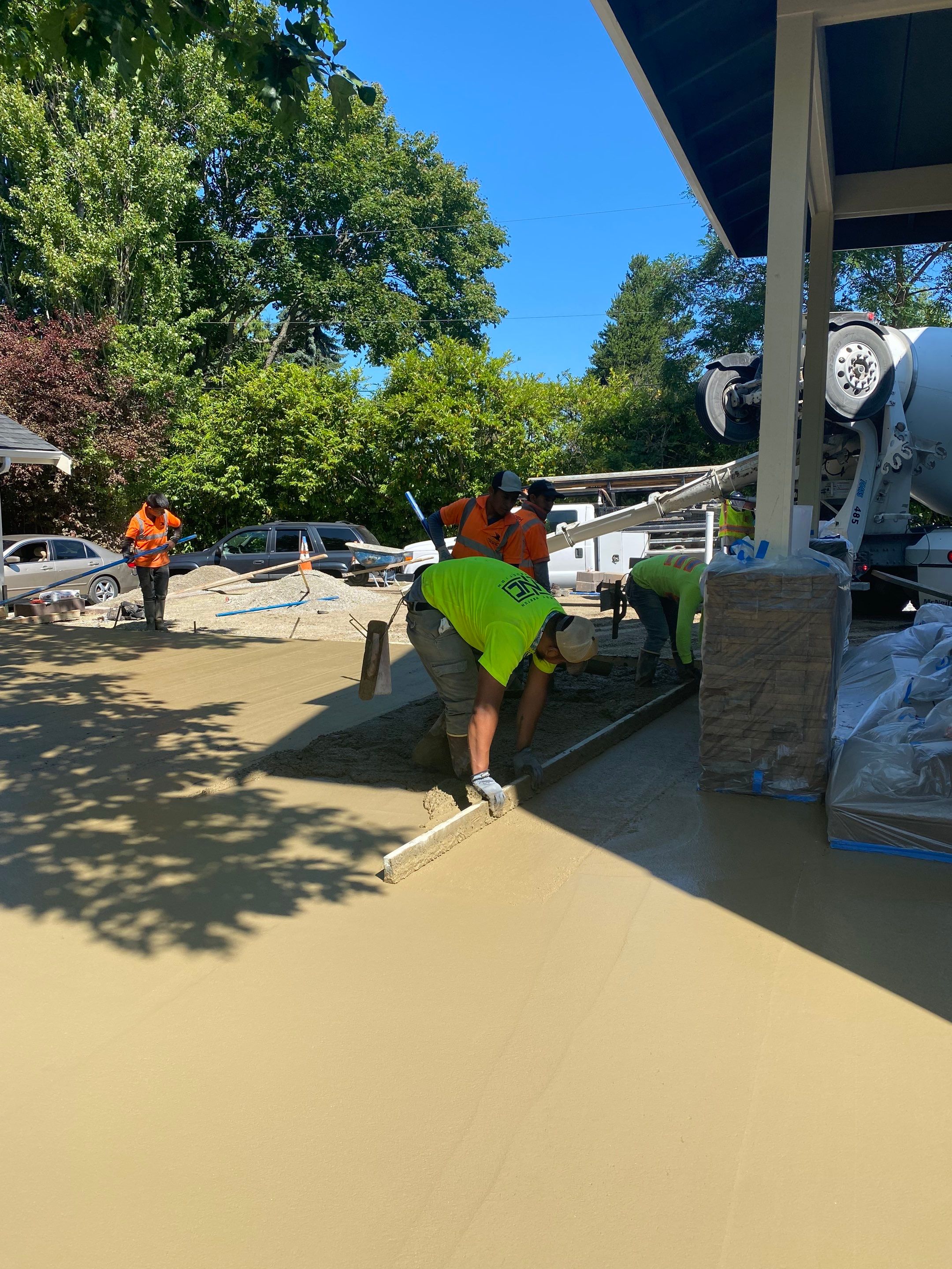 Patio Installation using Concrete, Retaining walls, and Turf install by Jireh Asphalt & Concrete Inc 