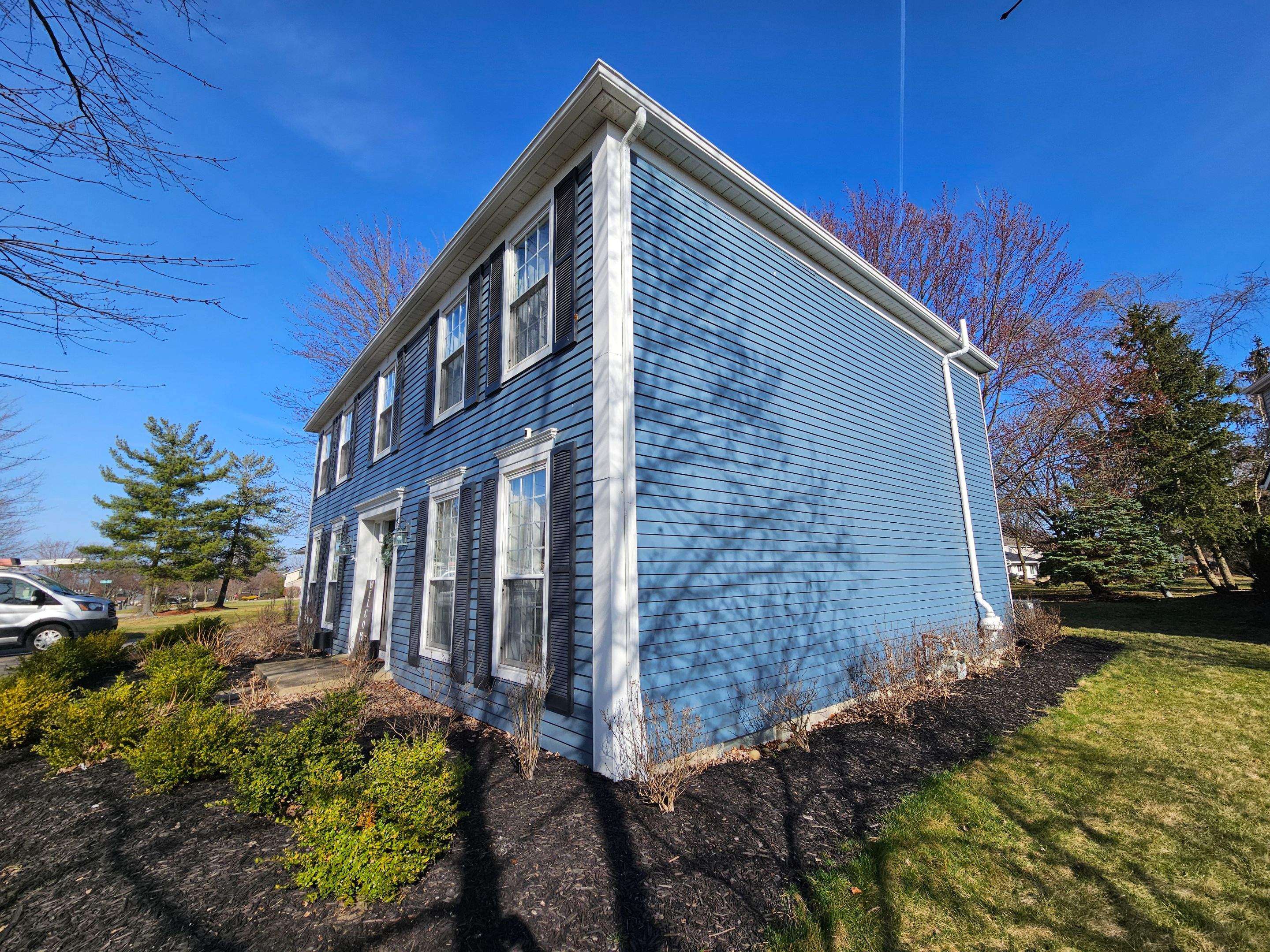 Vinyl Siding w. Stone Facade by Absolute Roofing and Construction