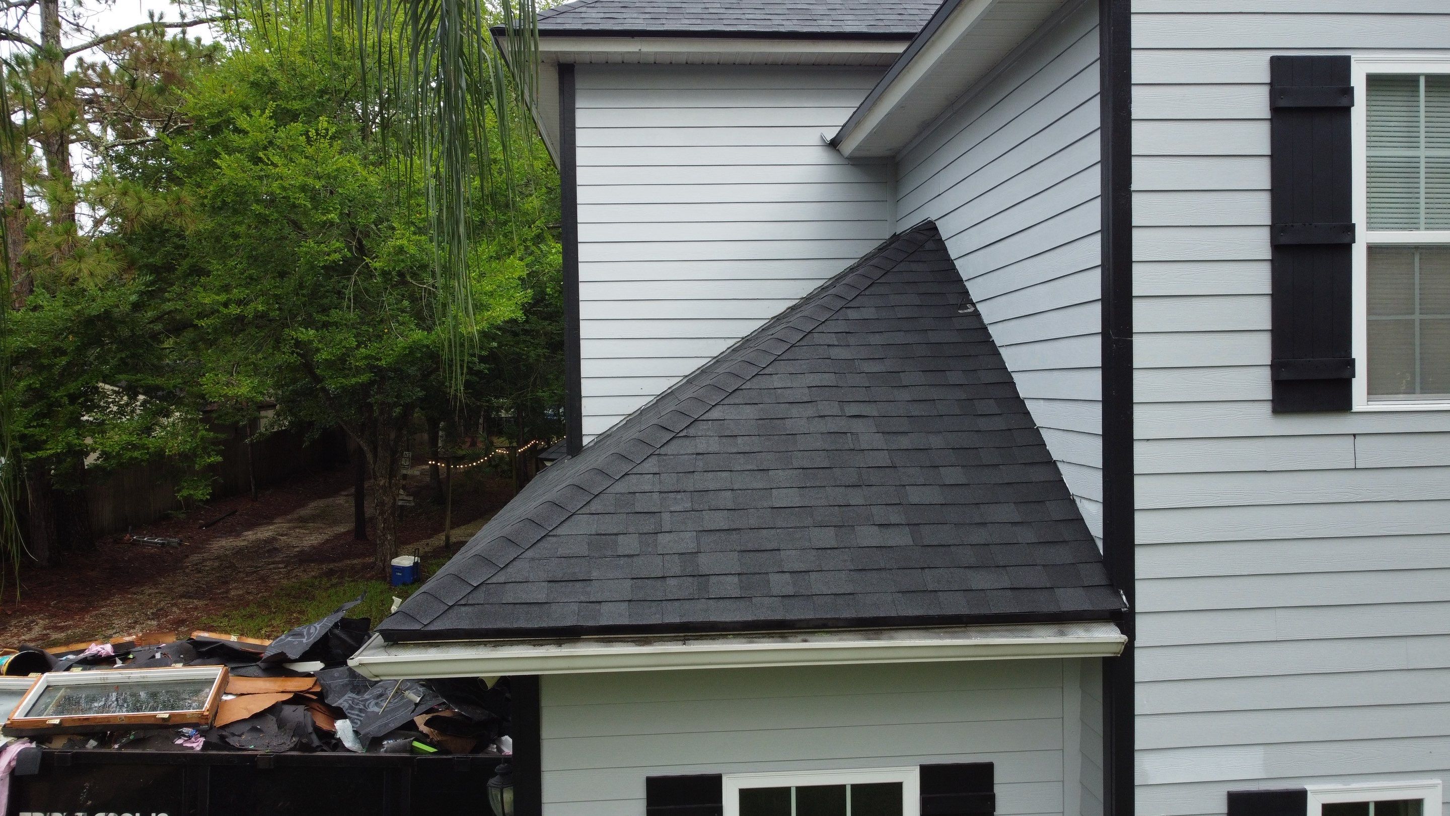 Complete Onyx Black Asphalt Shingle Roof Replacement and Skylight Installation in Jacksonville by Trinity Restoration and Roofing LLC