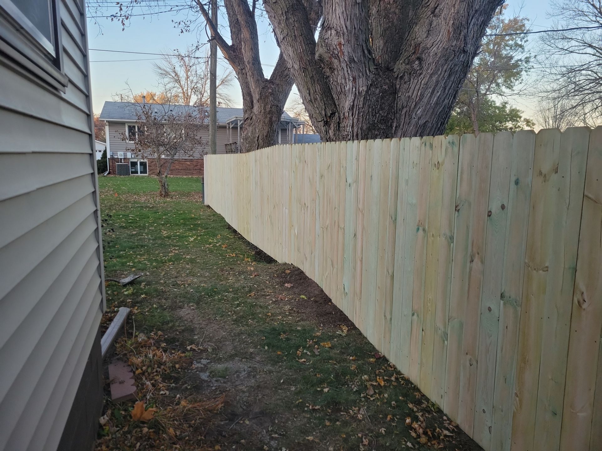 New Pressure-Treated Wood Privacy Fence and Gate in Charles City by Perfect Picket Fence and Stain