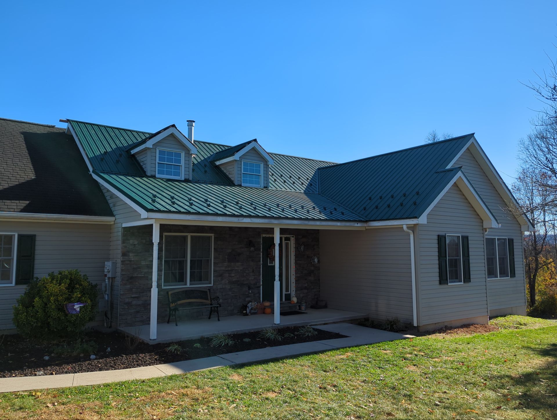 Green Metal Roof and Custom Covered Deck in Duncannon by Esh Builders