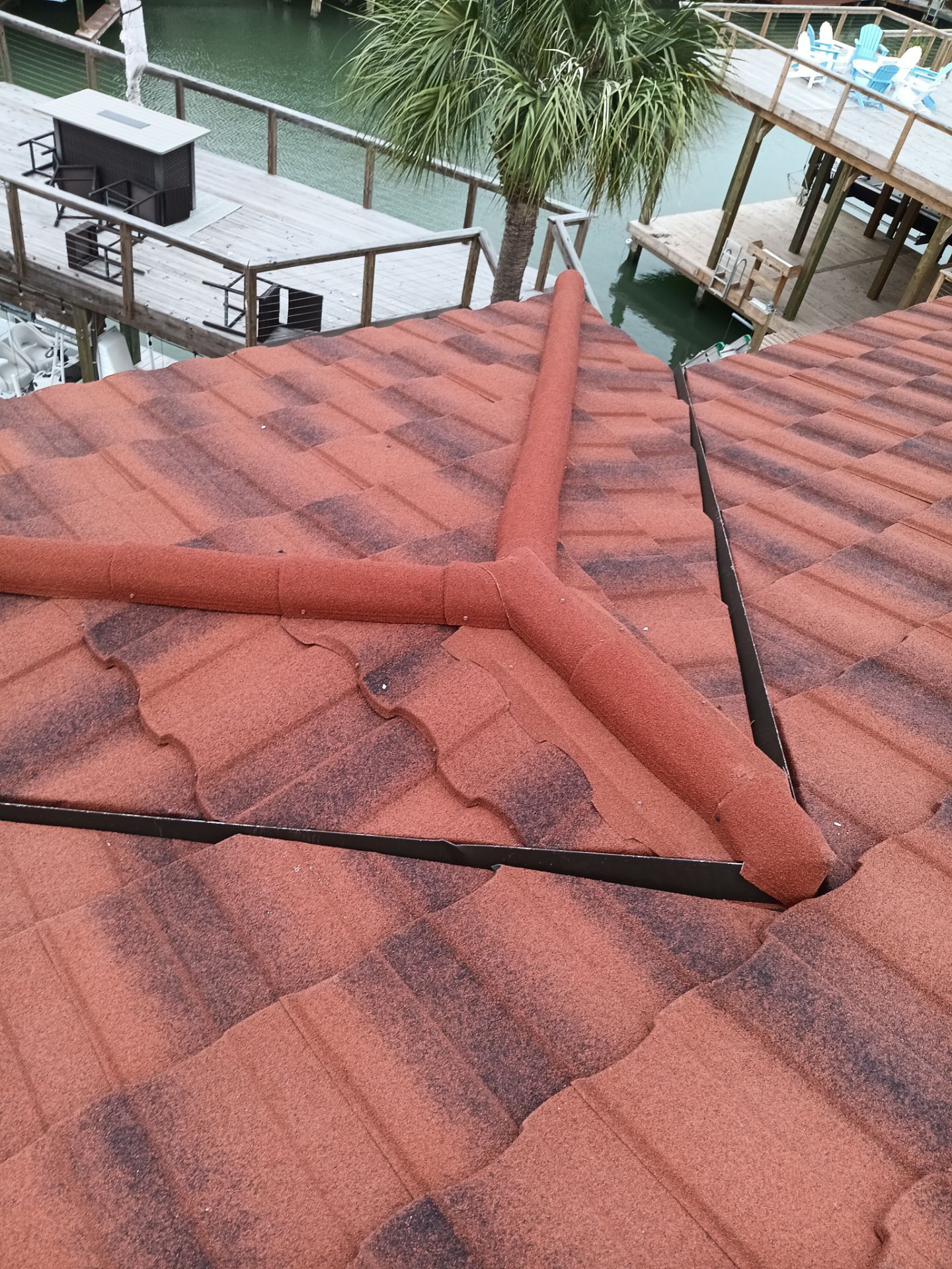 Off with the Tile and on with the TILCOR stone coated metal.  by Bayfront Roofing and Construction