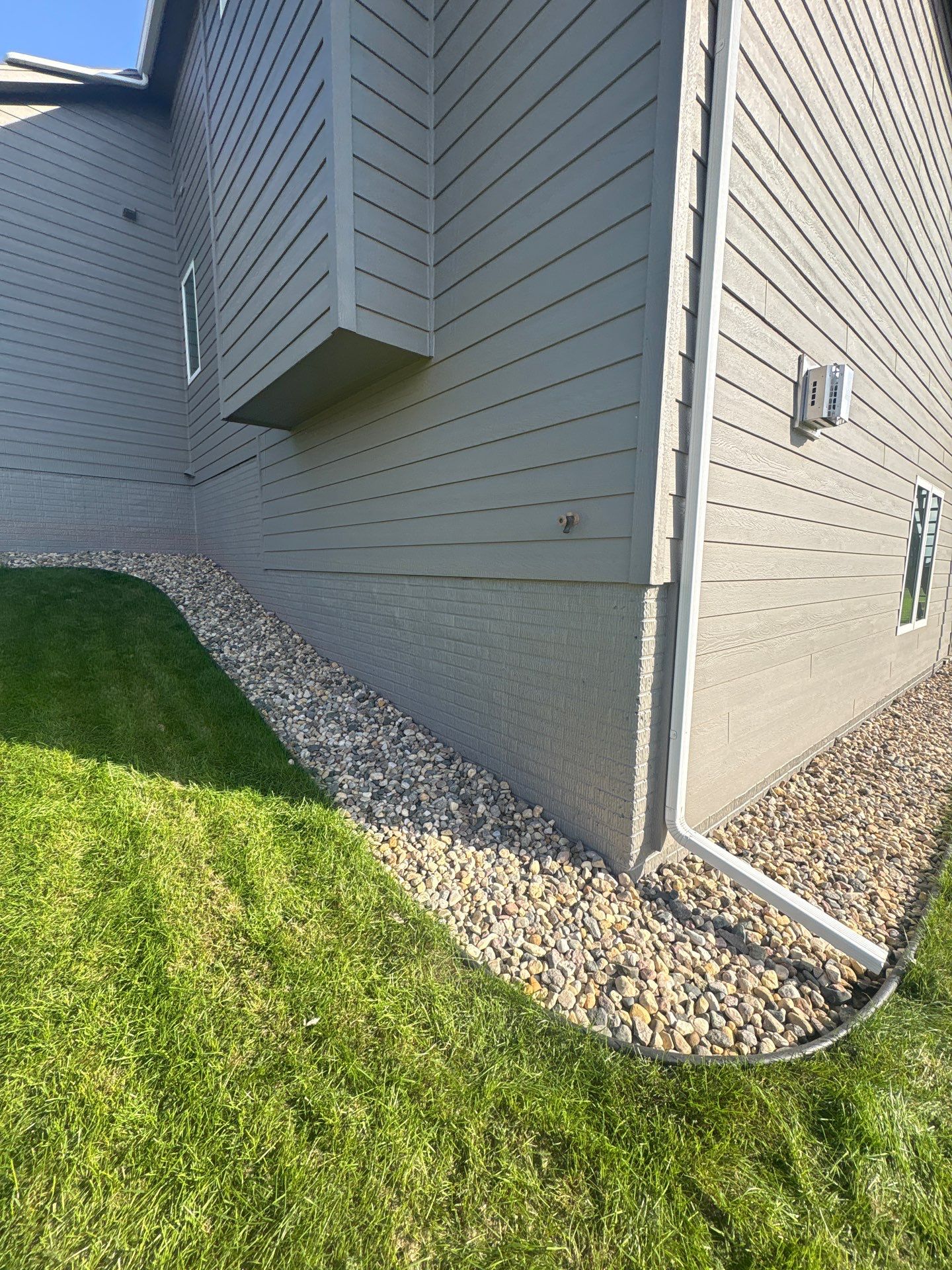 Gray Foundation Painting and Exterior Surface Refresh in Sioux Falls by Select Painting, Coatings & Garage Cabinets