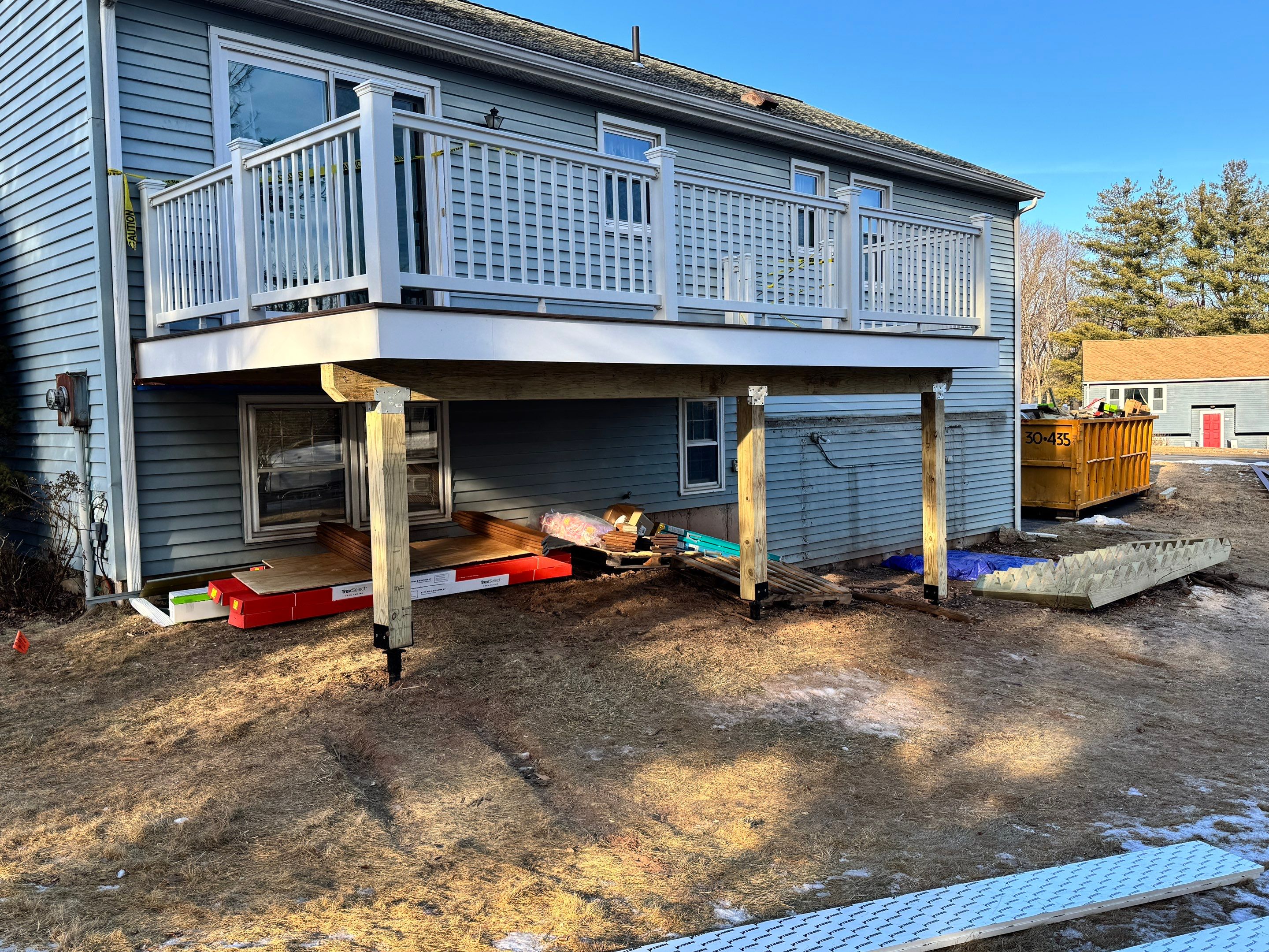 Deck replacement with Trex Select Saddle and White Select T rail. by DiGiorgi Roofing and Siding Inc