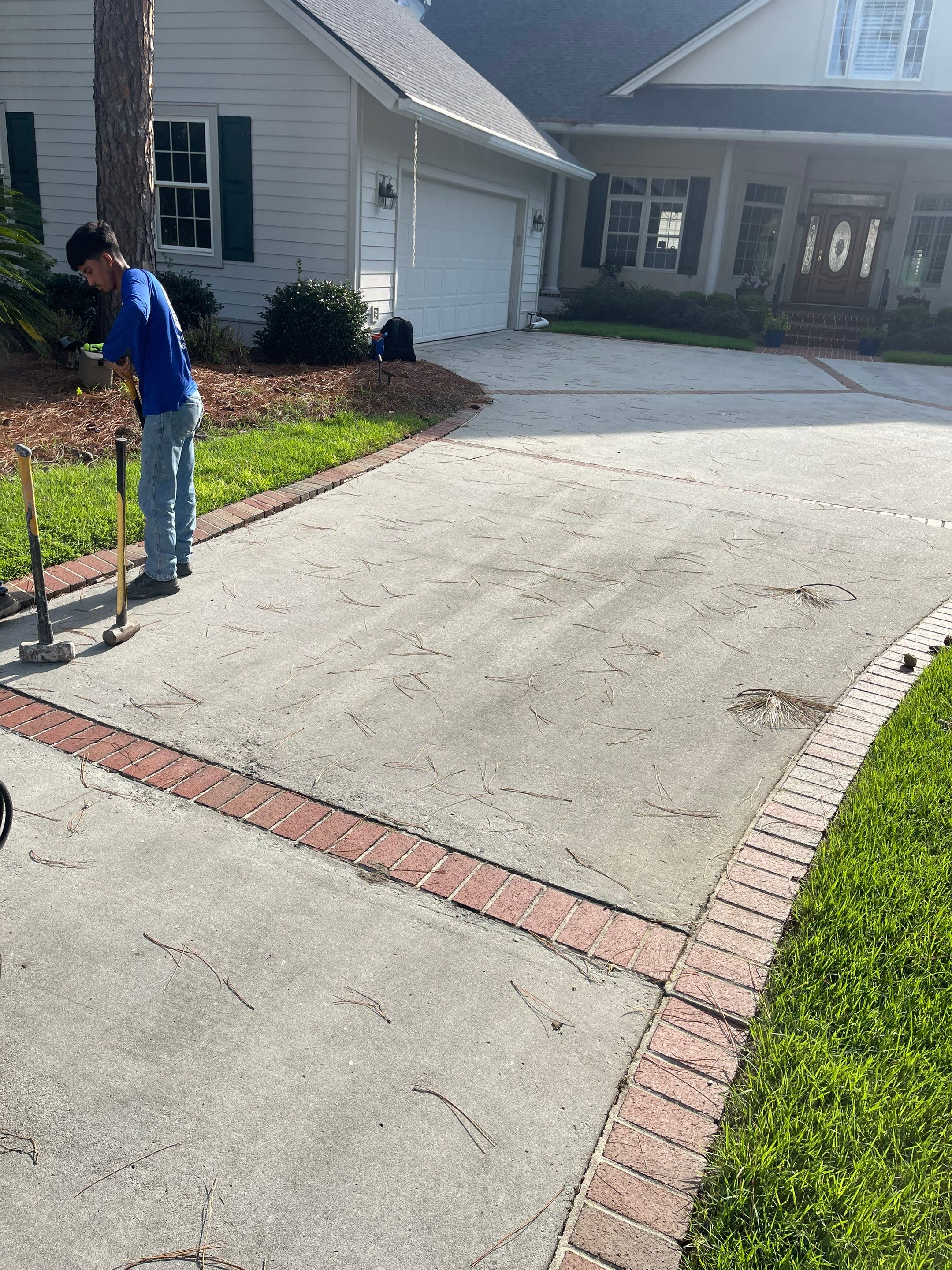 Concrete Driveway Cleaning and Restoration With Decorative Red Brick Border by Lowcountry Scapes, LLC