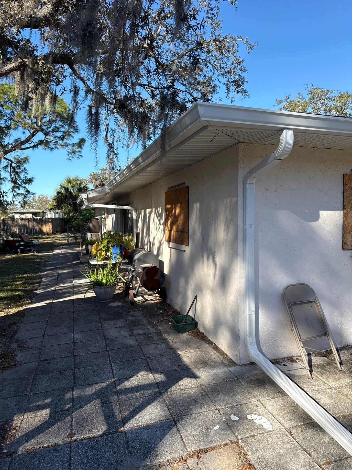 Downspout Installation using White Down Spouts in Sarasota FL by Gutter Professors