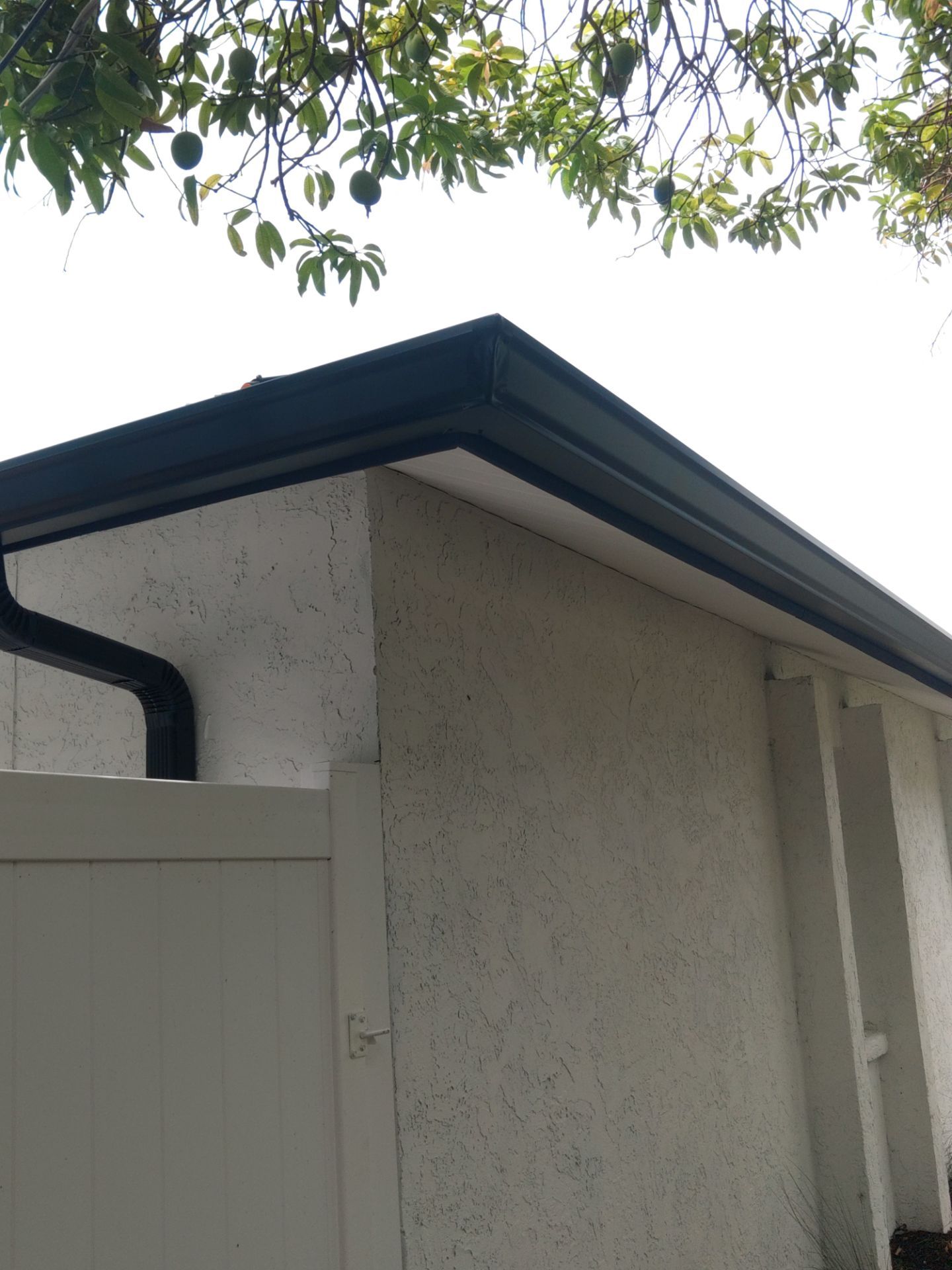 Black seamless gutters and downspouts installation in Sarasota, FL by Gutter Professors
