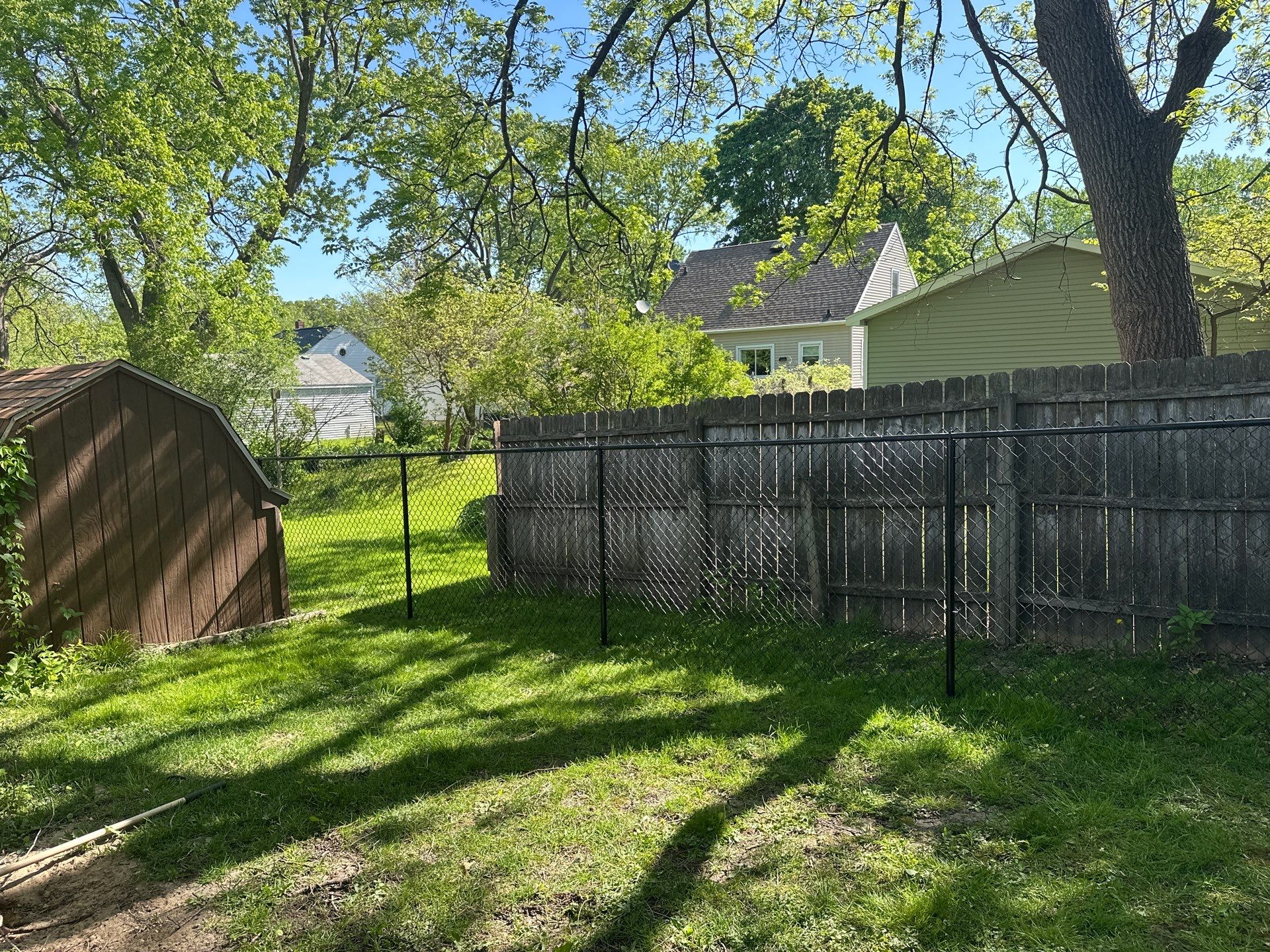 Black Chain Link Fence and Driveway Gate Installation in Waterloo by Perfect Picket Fence and Stain