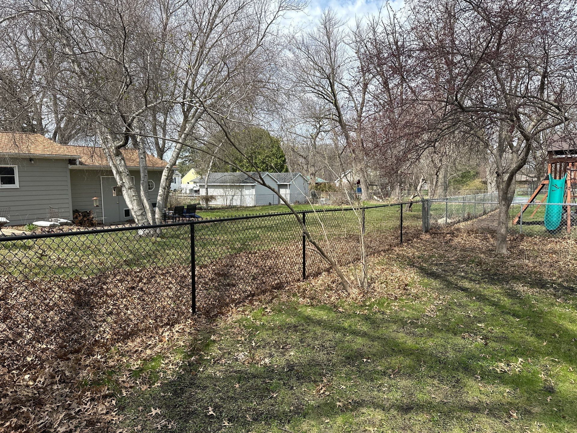 Black Vinyl-Coated Chain Link Fence Installation in Cedar Falls by Perfect Picket Fence and Stain