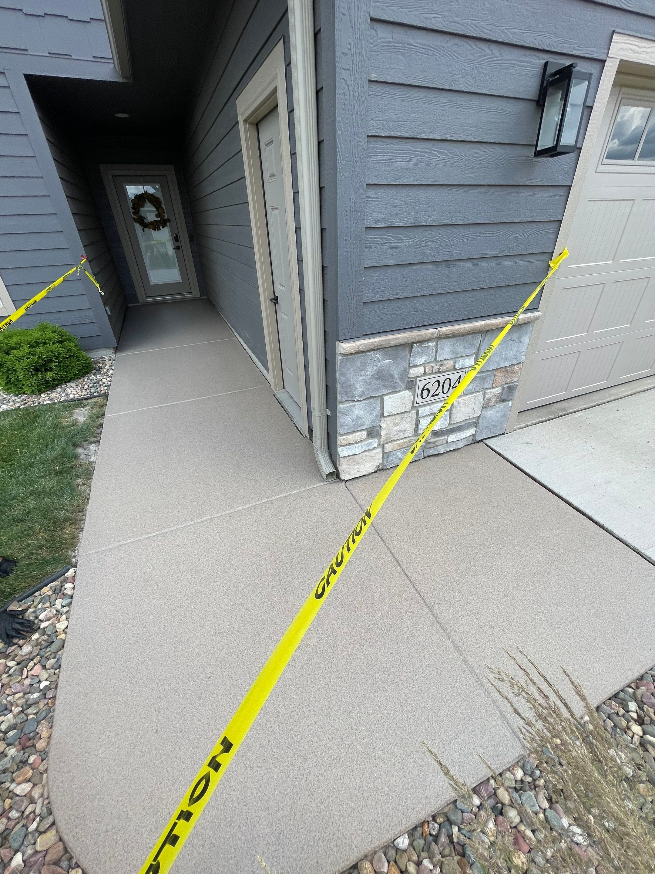 Textured Concrete Patio Coating and Custom Privacy Pergola in Sioux Falls by Select Painting, Coatings & Garage Cabinets