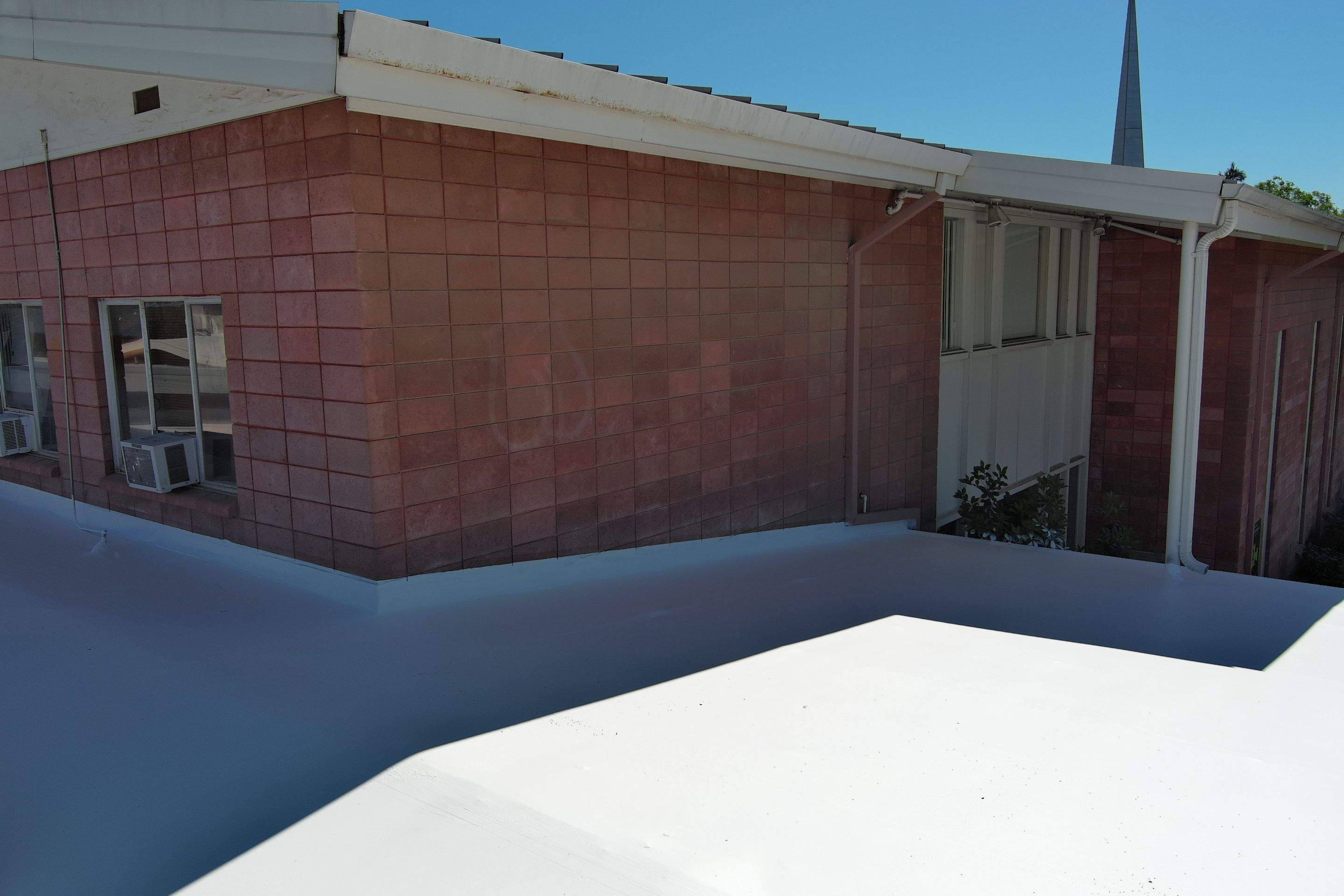 Single-ply restoration system using Benchmark/PUMA XL coatings over TPO single-ply roofing by Straight Edge Roofing Inc