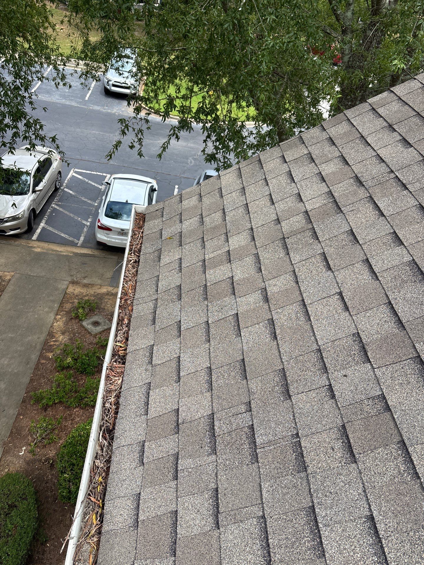 Commercial gutter cleaning Warner Robins & Perry, GA before photo with filled gutters