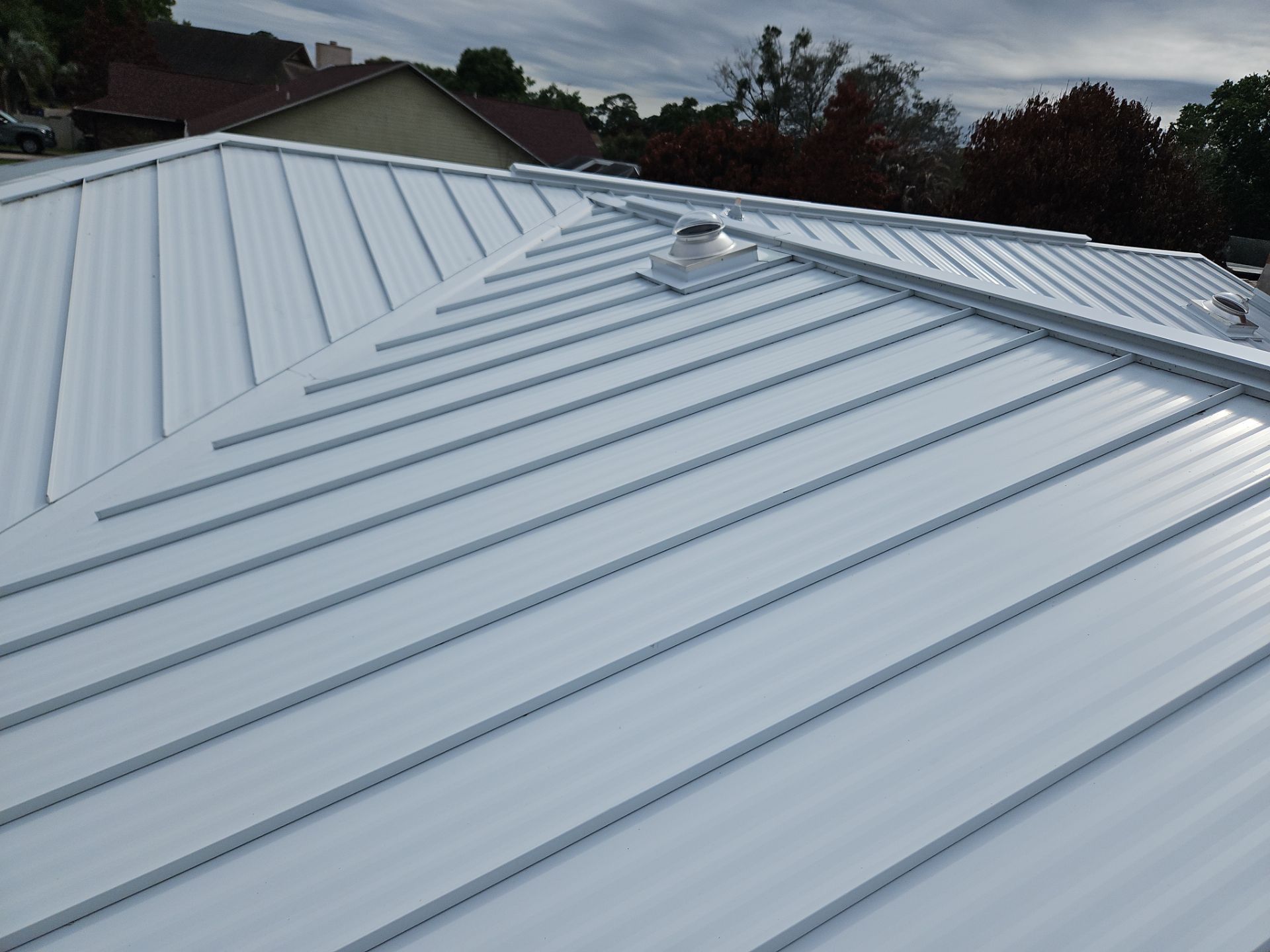 White Standing Seam Metal Roof Replacement and Hurricane Reinforcement in Palm Bay, Florida by Wiedmann Construction & Roofing
