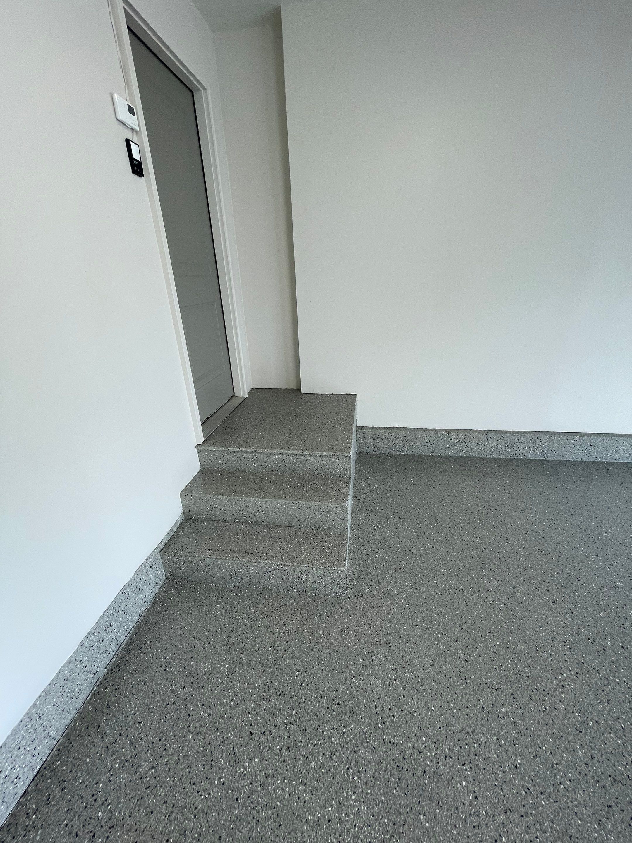 Residential Garage Floor Coating with Grey Speckled Epoxy Finish by Select Painting, Coatings & Garage Cabinets