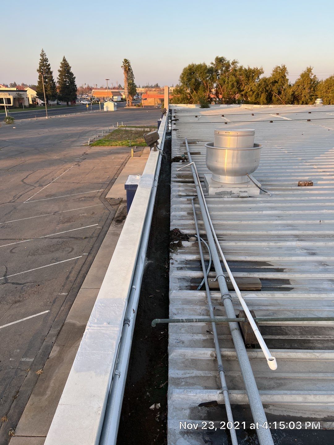 Metal roof restoration on commercial roof using Conklin Benchmark/ PUMA XL acrylic coatings over metal and foam by Straight Edge Roofing Inc