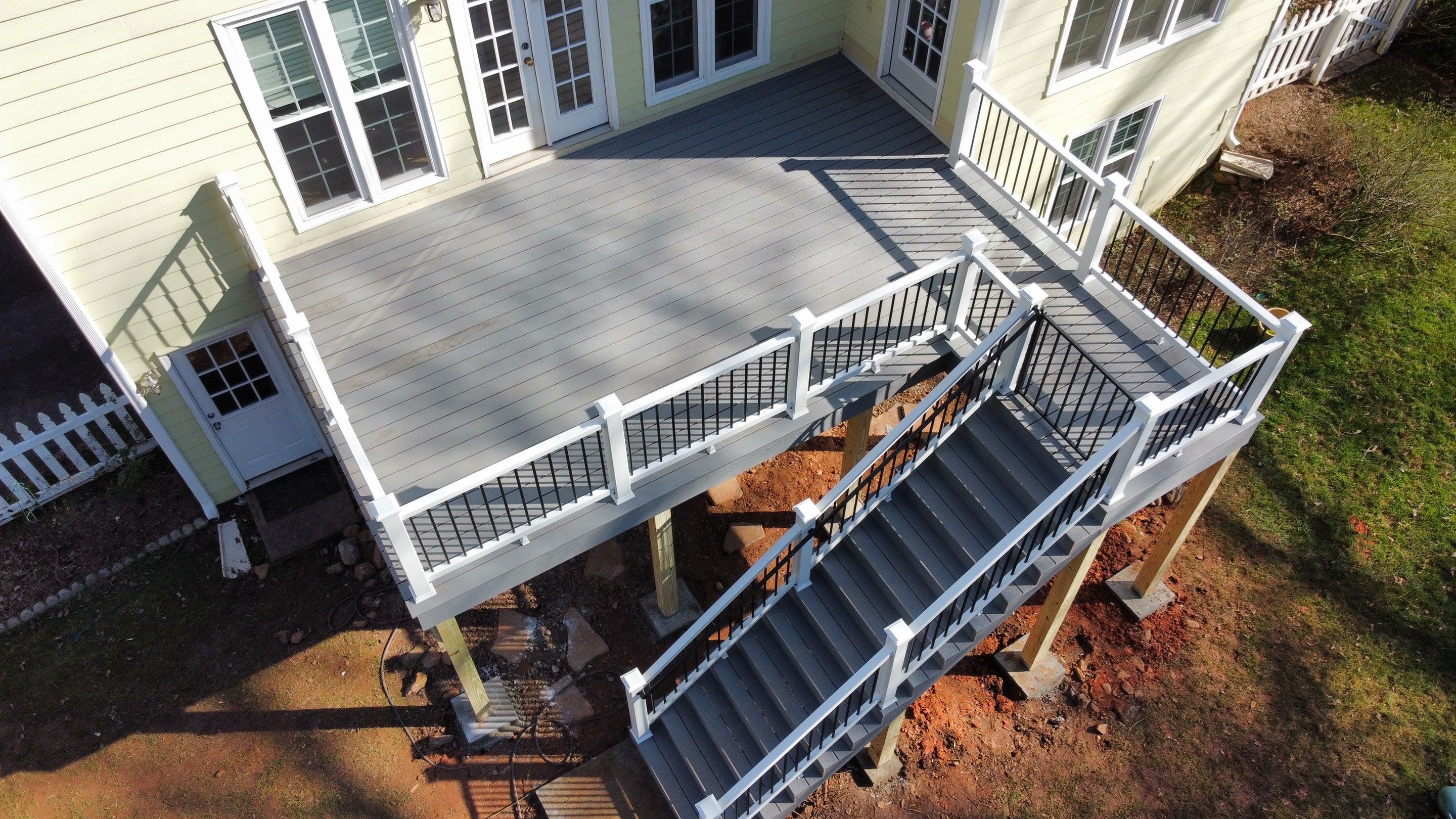 Elevated Grey Composite Deck Installation in Woodstock, Georgia by Swift Home Renovations