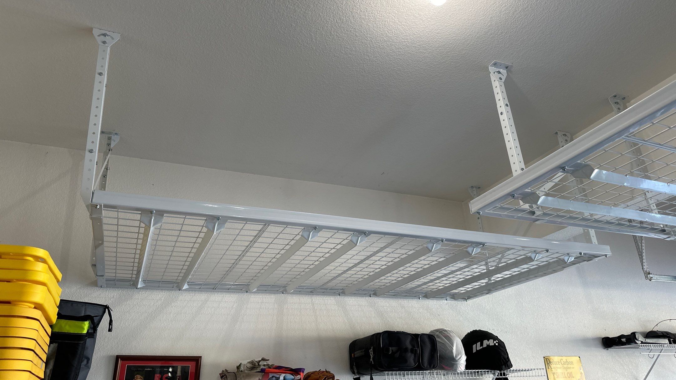 Darlene maximized their storage with overhead racks.  by Banner Garage