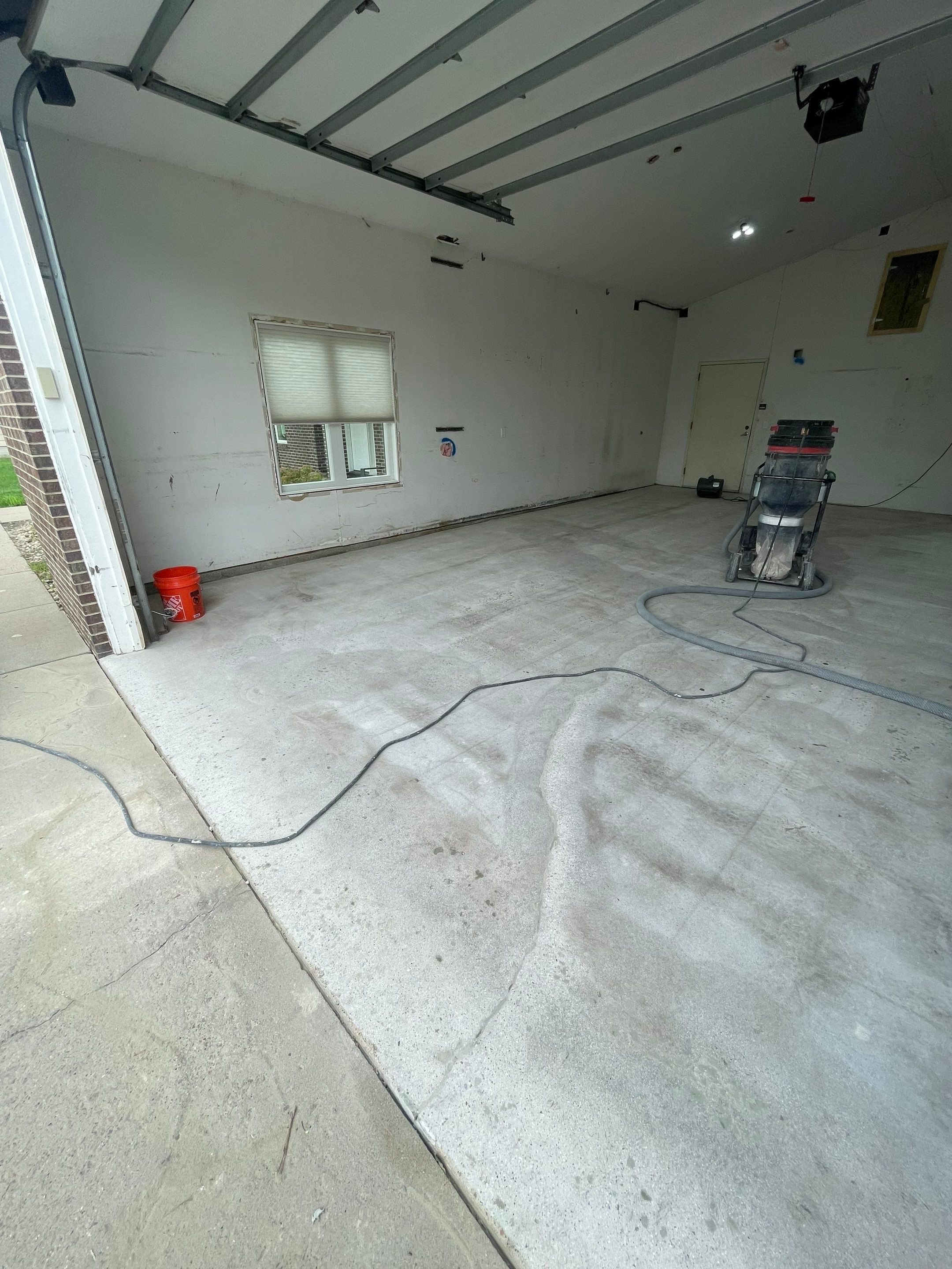 Coyote Flake Concrete Coating for Sioux Falls Garage by Select Painting, Coatings & Garage Cabinets