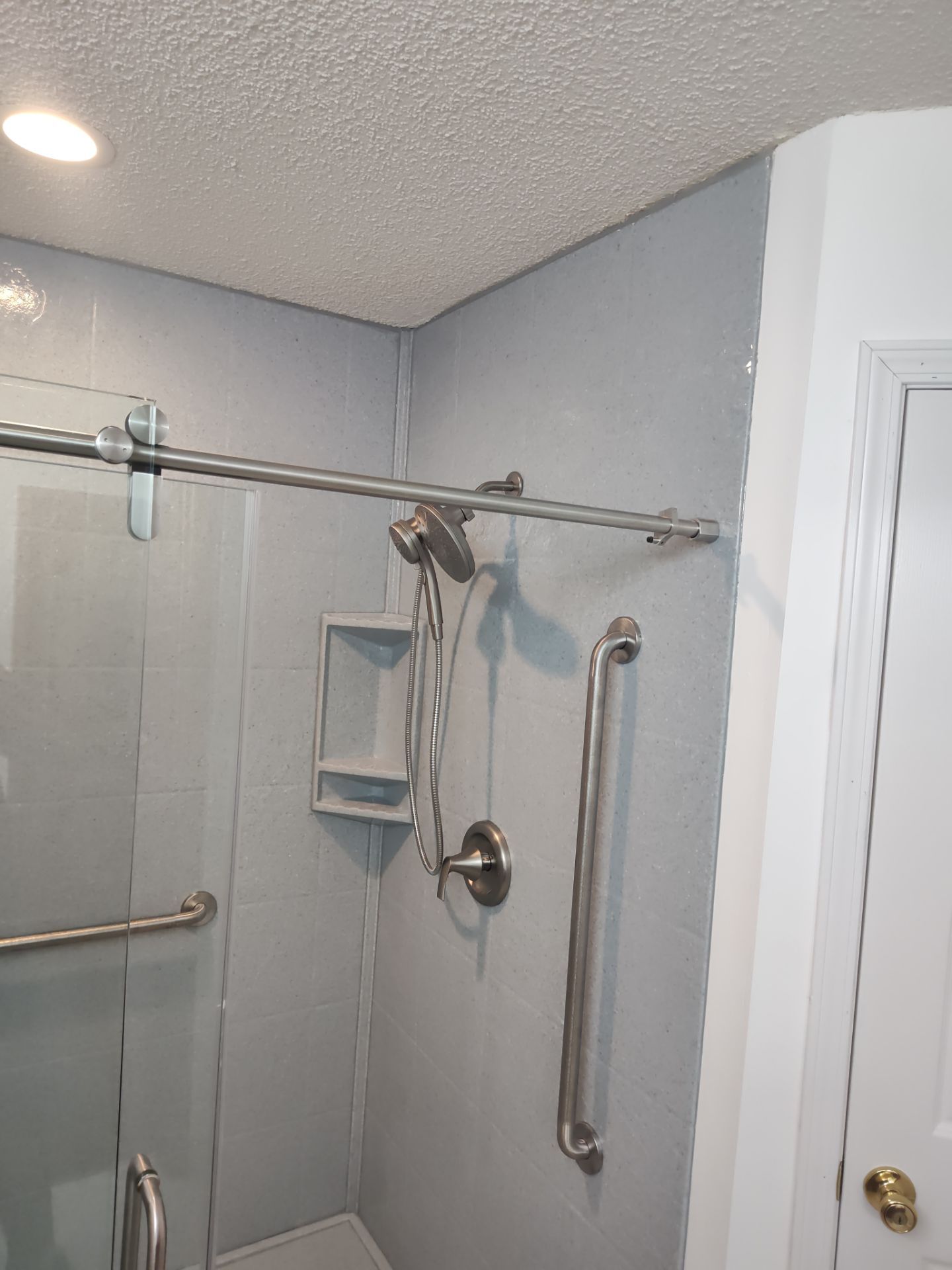 Bathroom Remodel using Onyx base and shower walls with seat & caddie by Cornerstone Home Builders, LLC