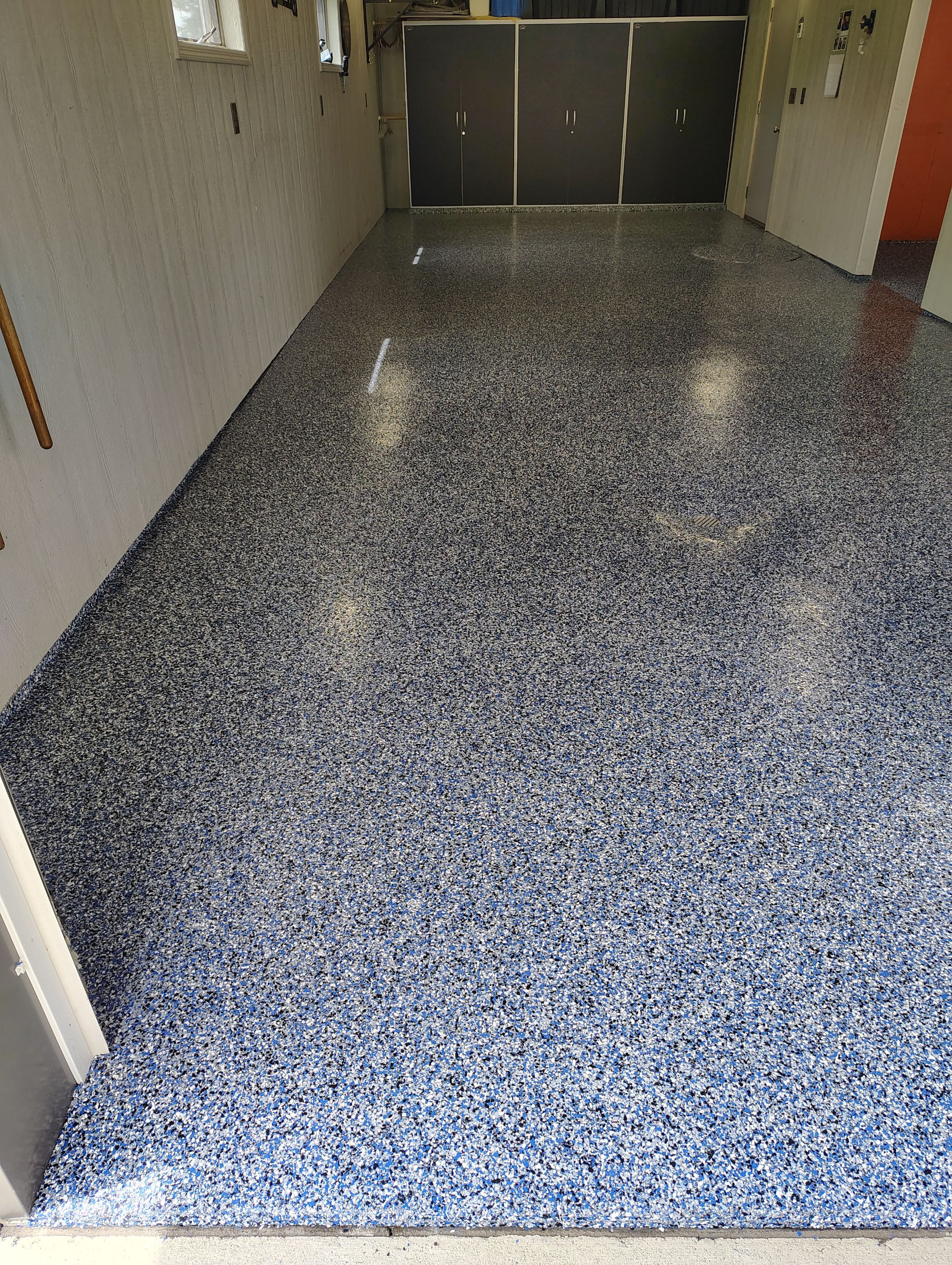 Custom Grey Flake Epoxy Garage Floor Installation in Remsen by Select Painting, Coatings & Garage Cabinets