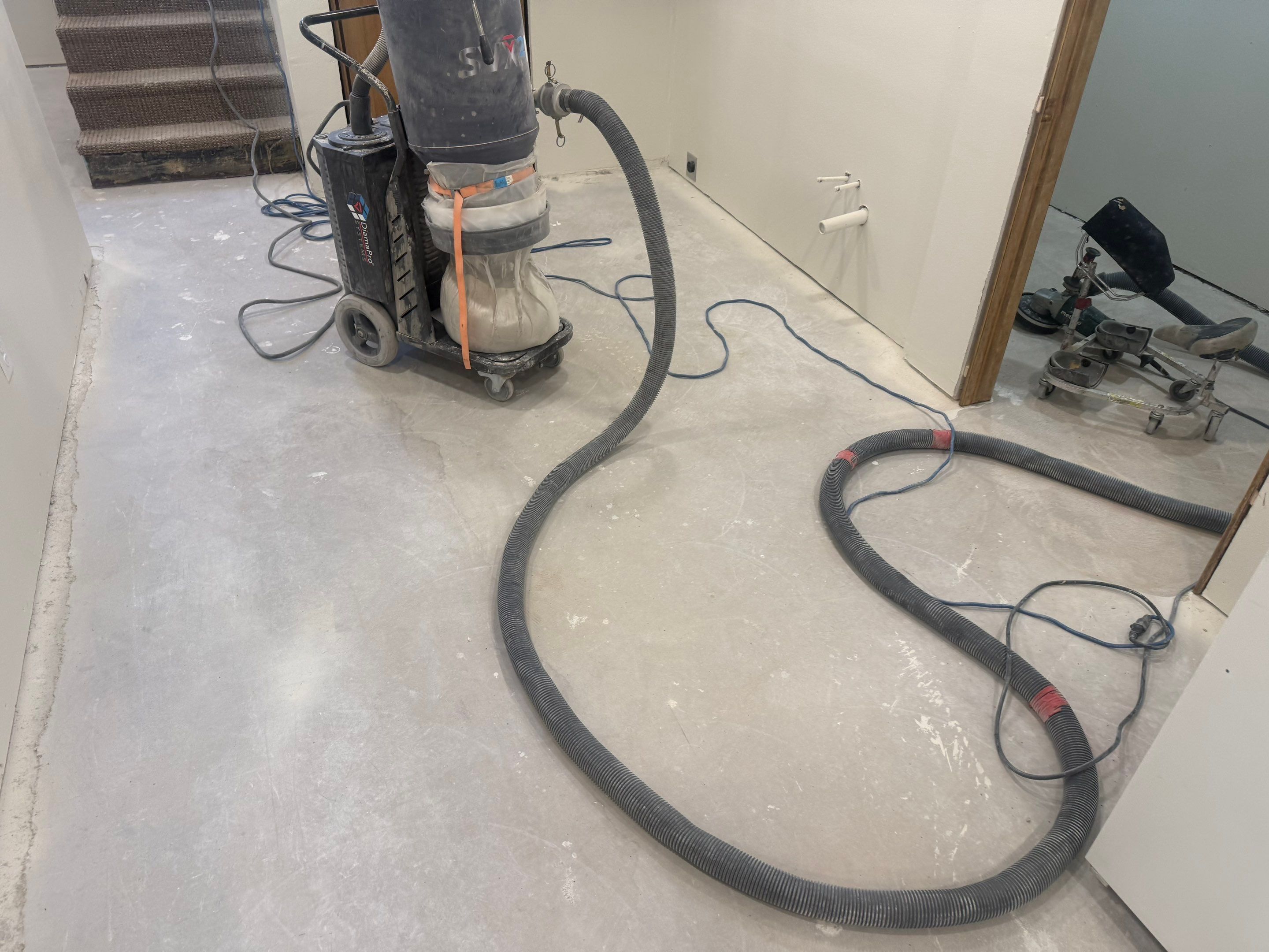 High-Gloss Epoxy Floor Coating and Basement Renovation in Rock Rapids by Select Painting, Coatings & Garage Cabinets