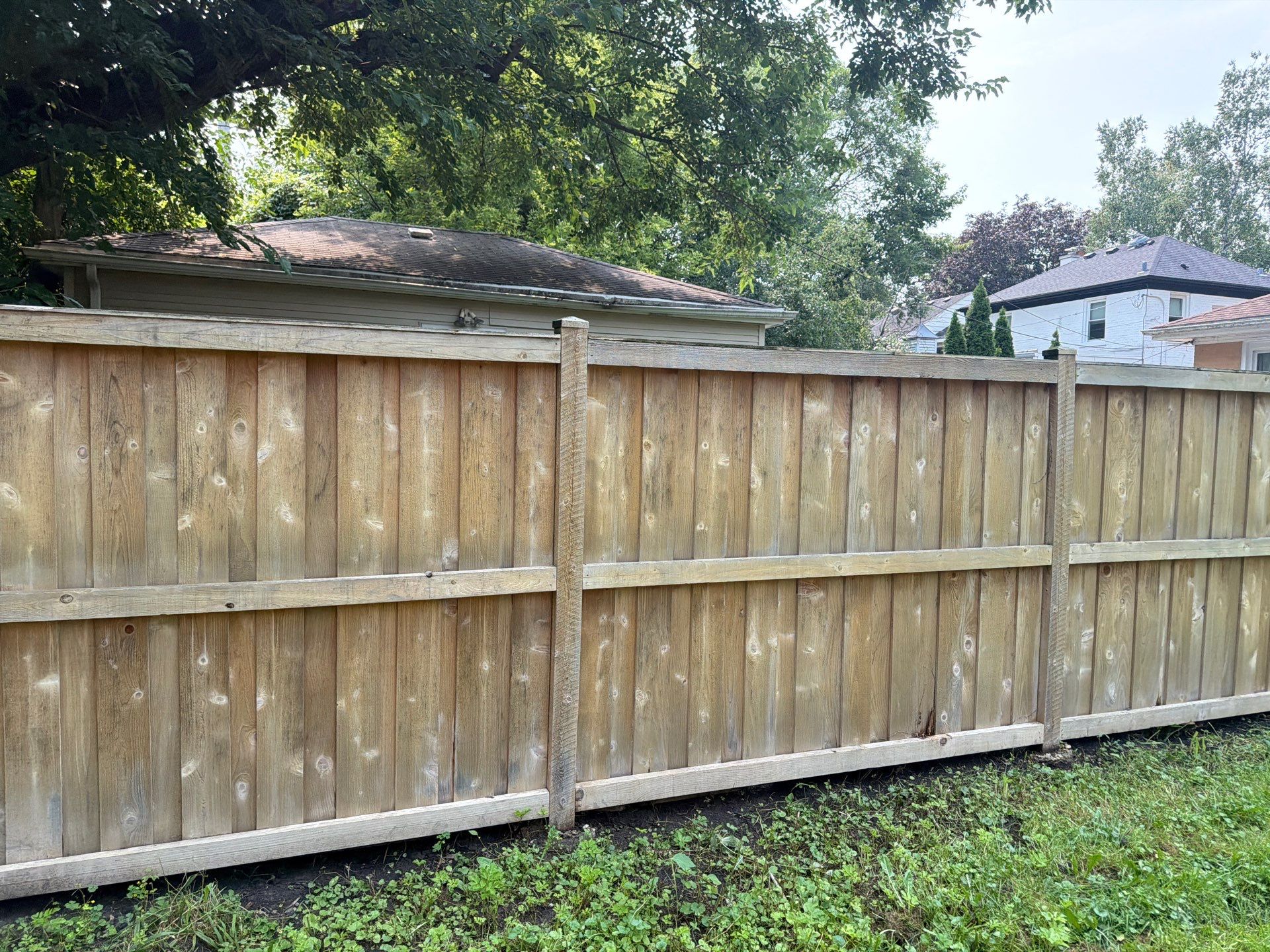 Wood fence cleaning and sealing by Northern Power Washing LLC.