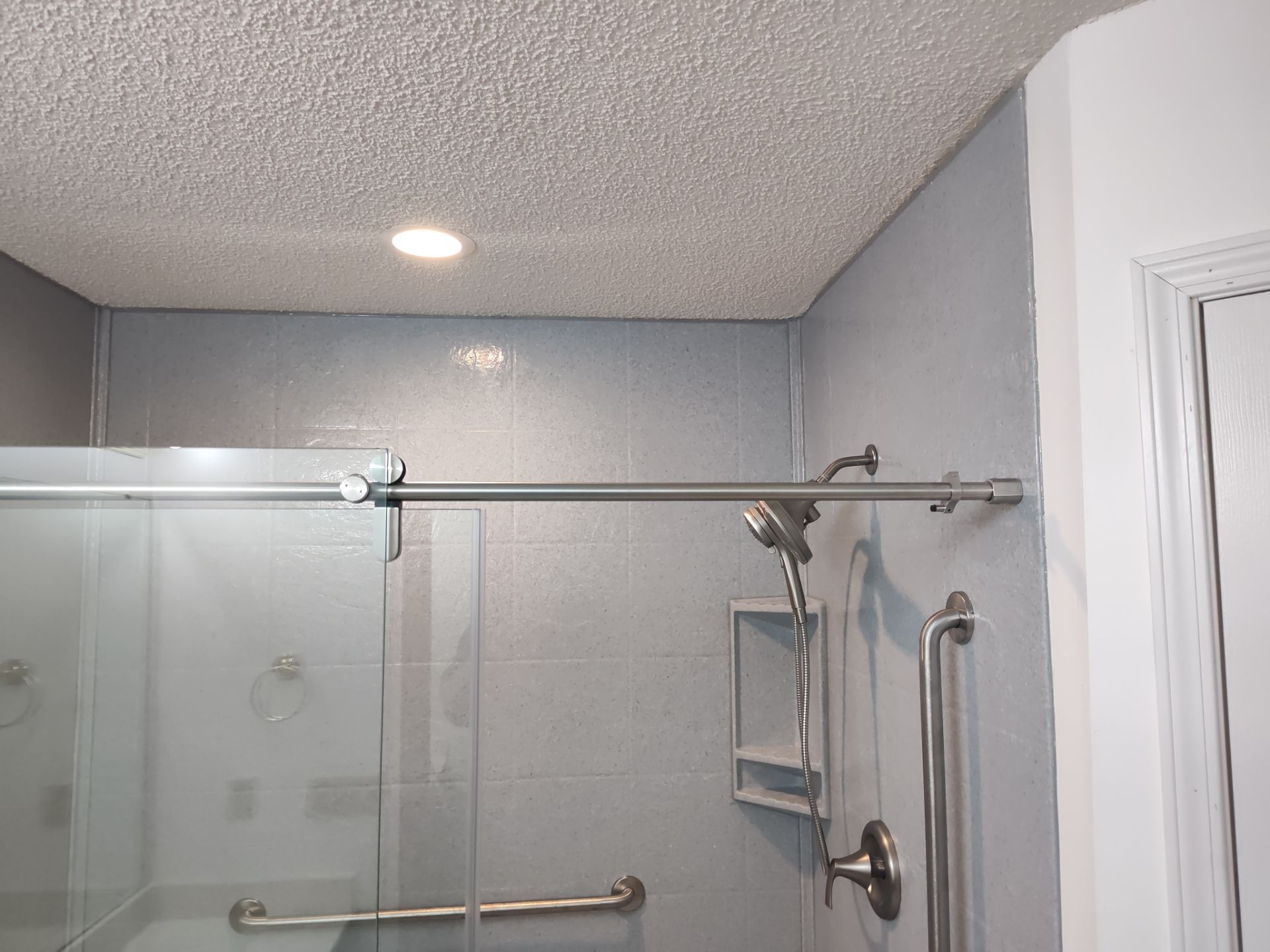 Bathroom Remodel using Onyx base and shower walls with seat & caddie by Cornerstone Home Builders, LLC