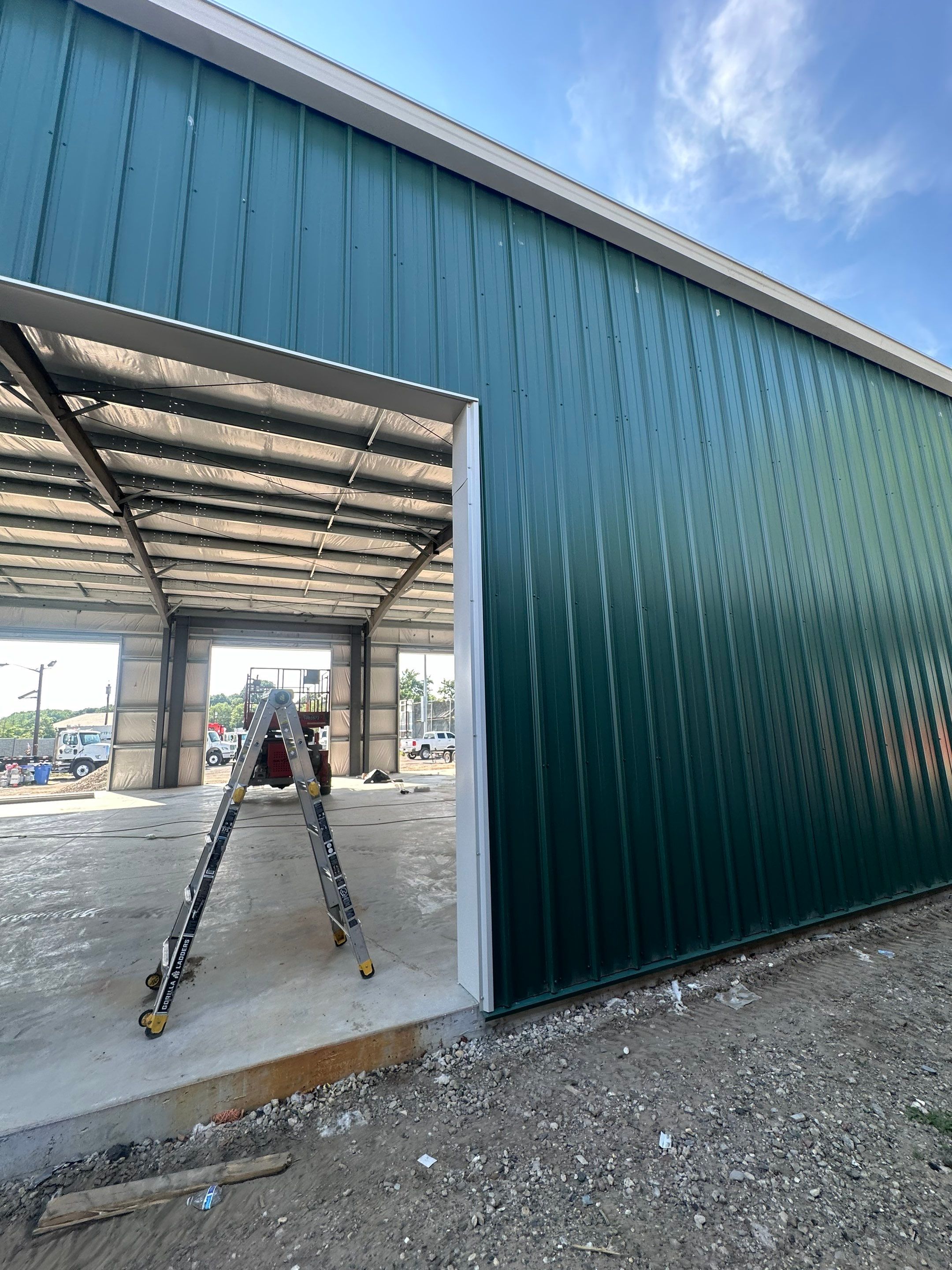 Dark Green Metal Siding by Reimagine Roofing