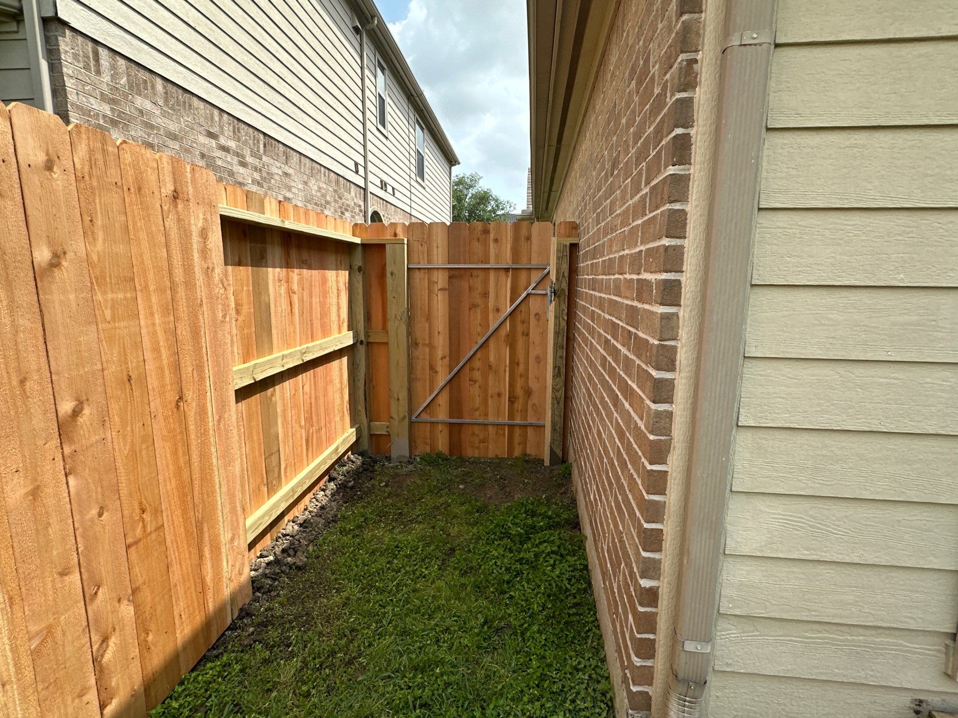 Wood fence with alternating panels by Tim's Fences