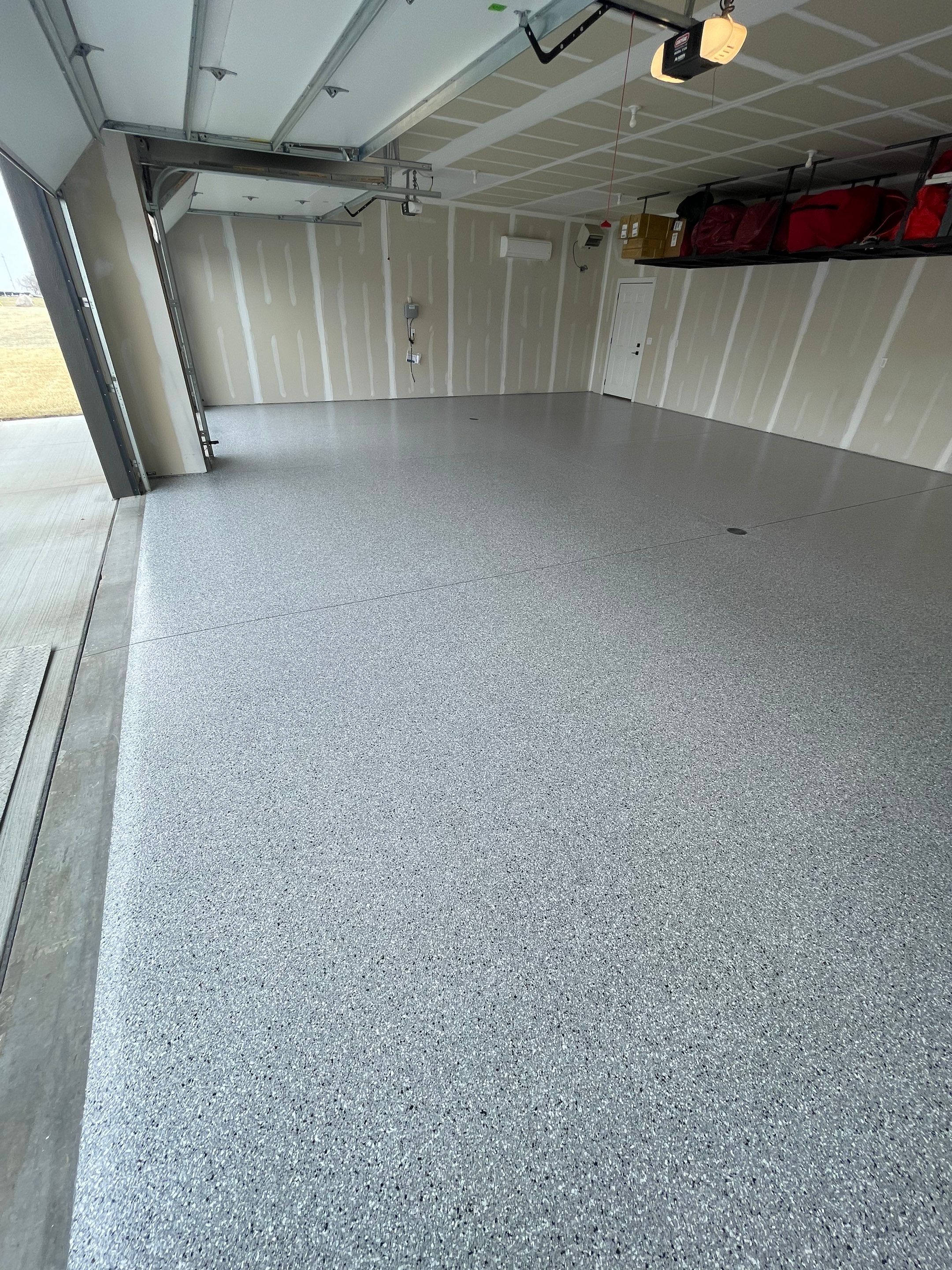 Grey Speckled Epoxy Floor Coating for Sioux Falls Garage by Select Painting, Coatings & Garage Cabinets