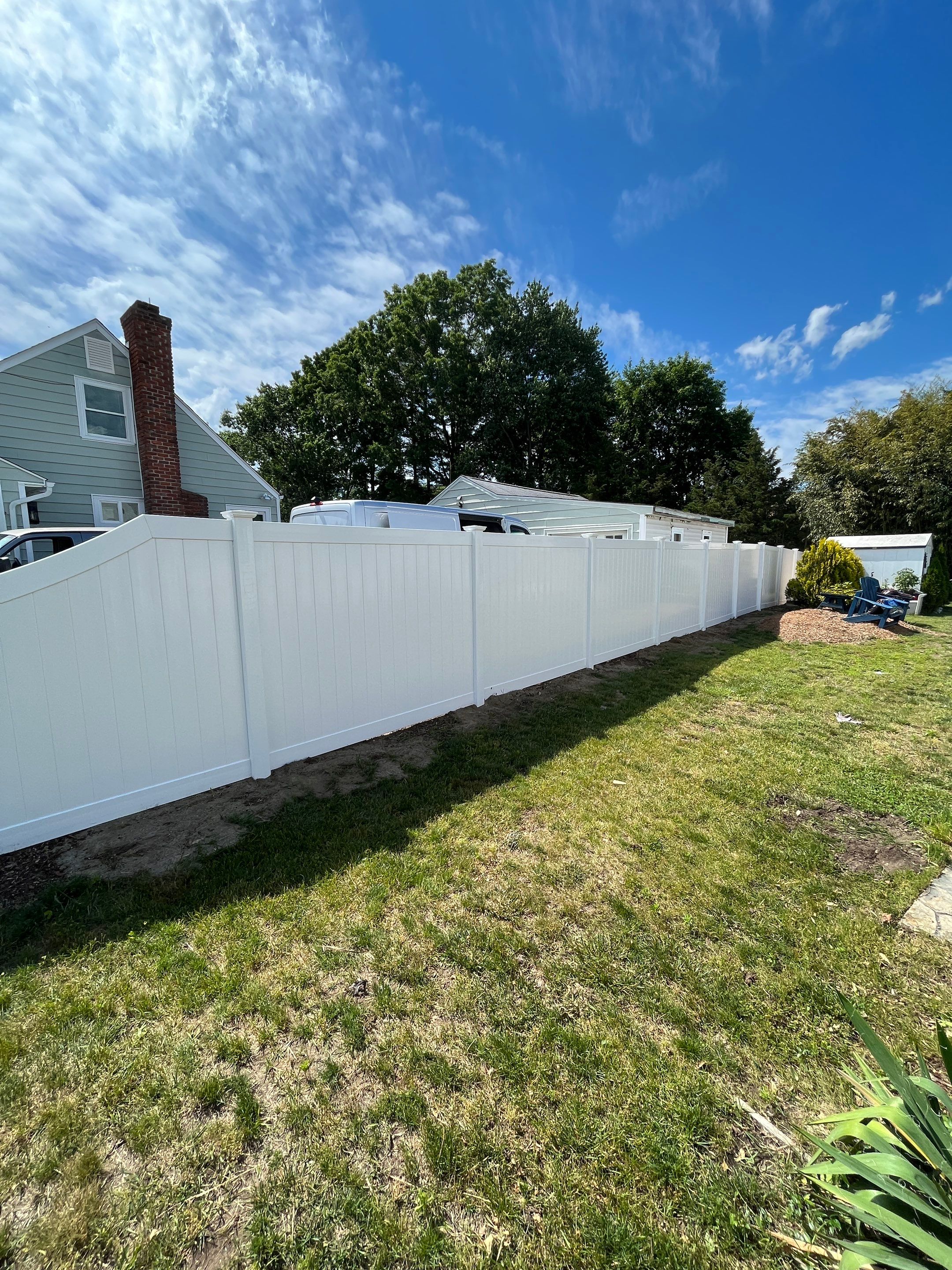 Replacement Vinyl Privacy fence with Transition piece in White by DiGiorgi Roofing and Siding Inc