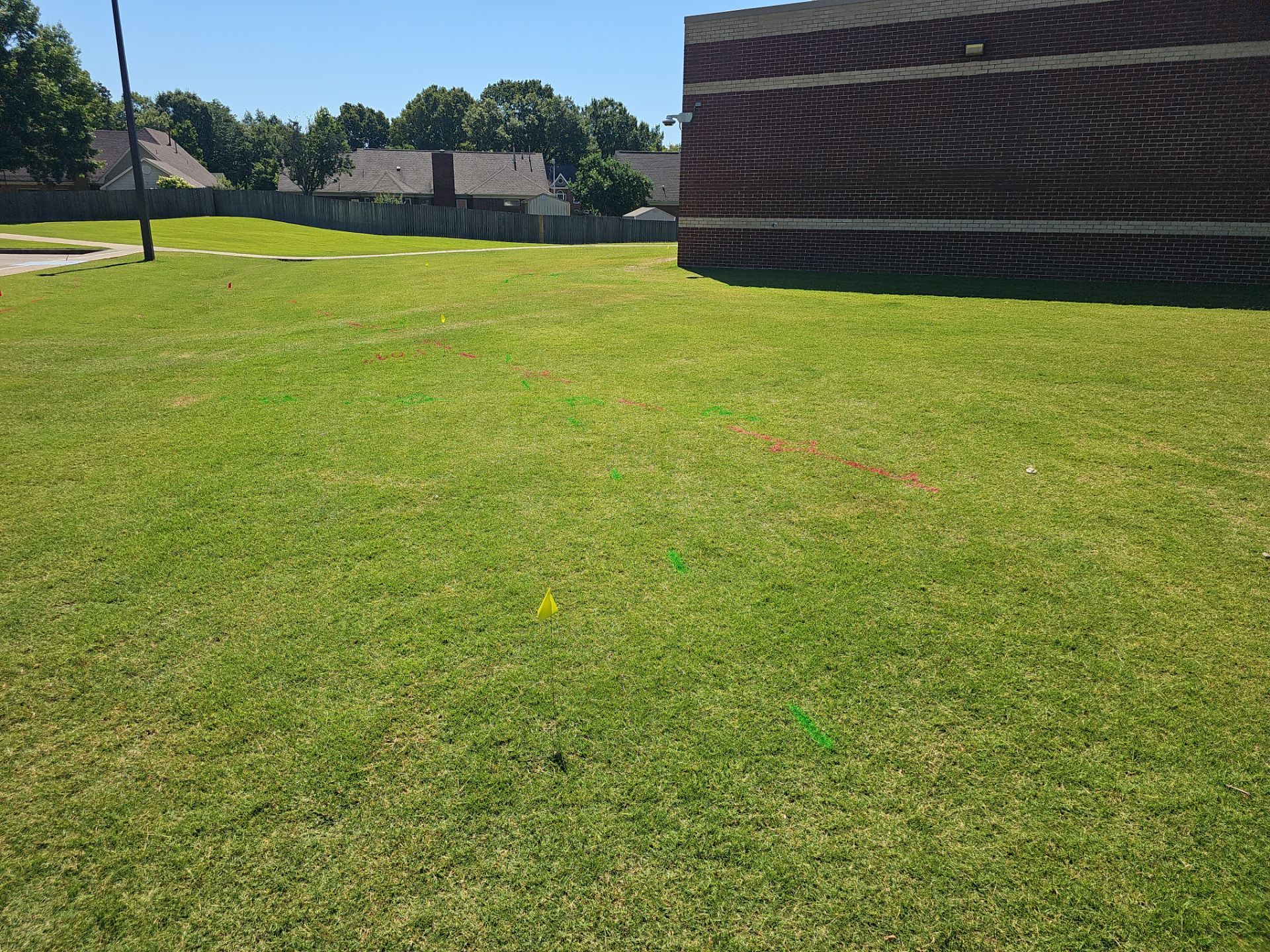 Utility Locating at a school for fence install by Alsip Locating Service, LLC