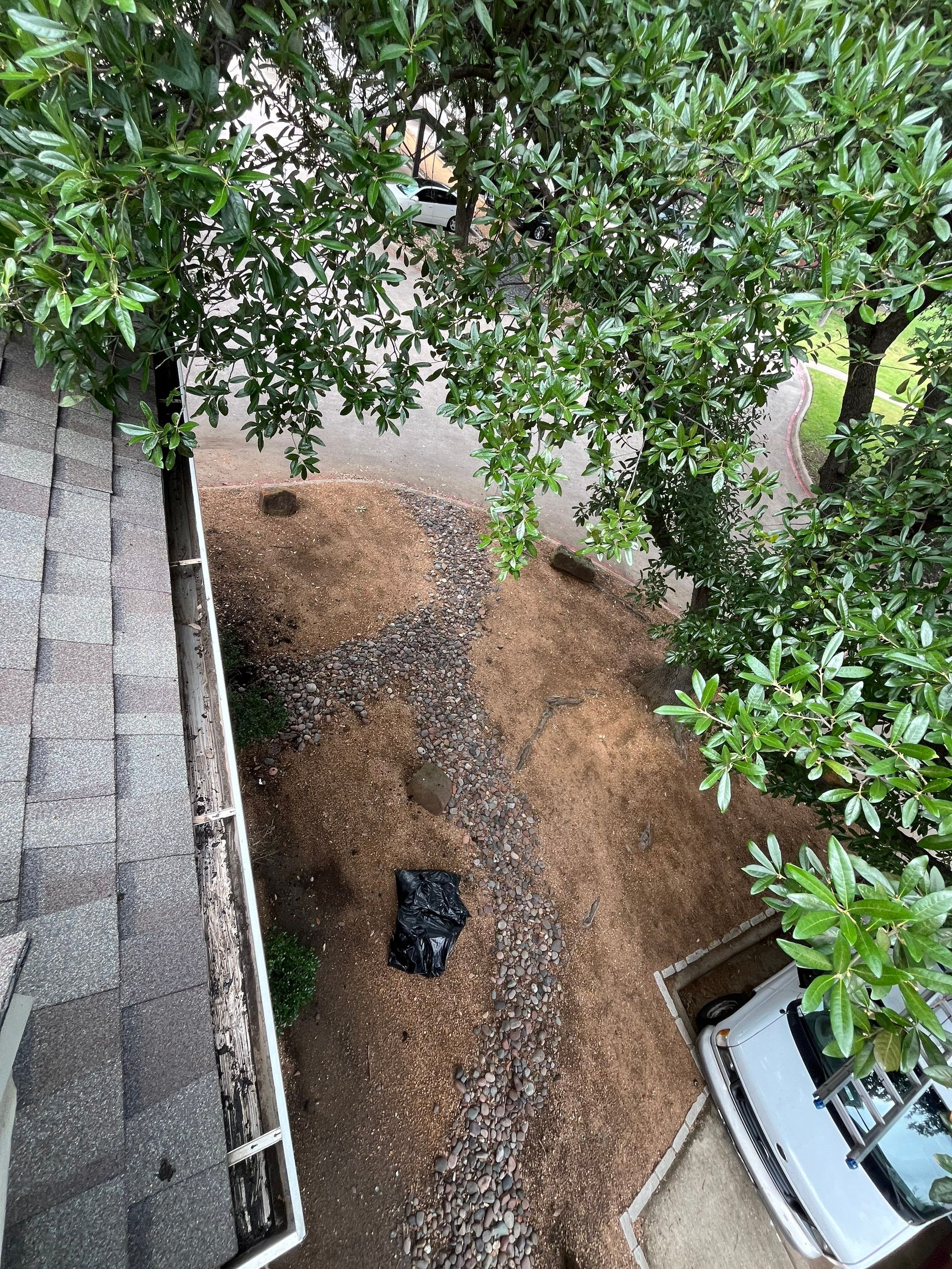 HOA gutter cleaning in Allen, TX, after  photo showing full gutters.