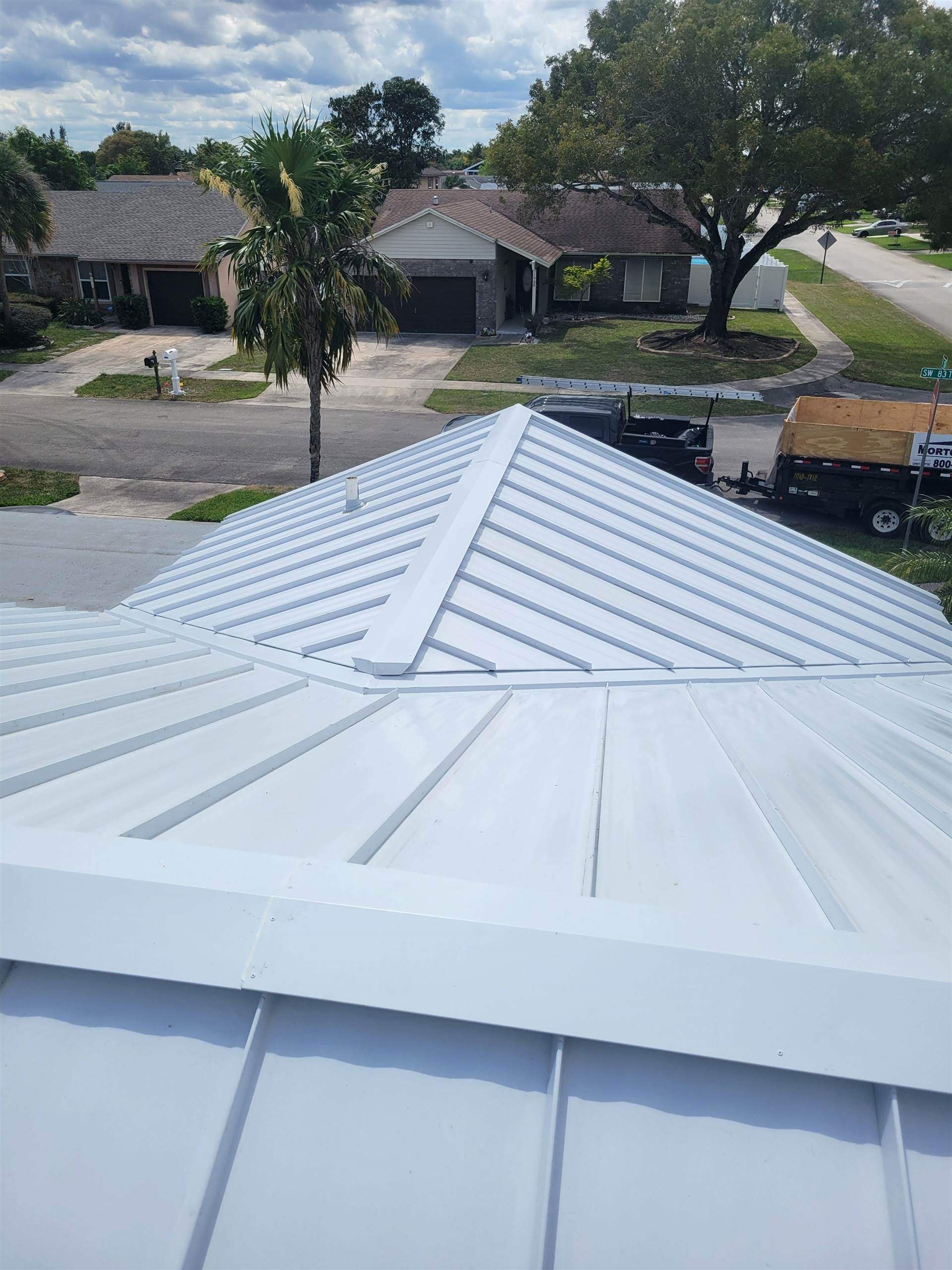 Standing Seam Metal & Flat Re-Roof using 1.5" Nail Strip 24ga Solar White Kynar Coated Standing Seam Metal Panels by Morton Roofing, Inc.