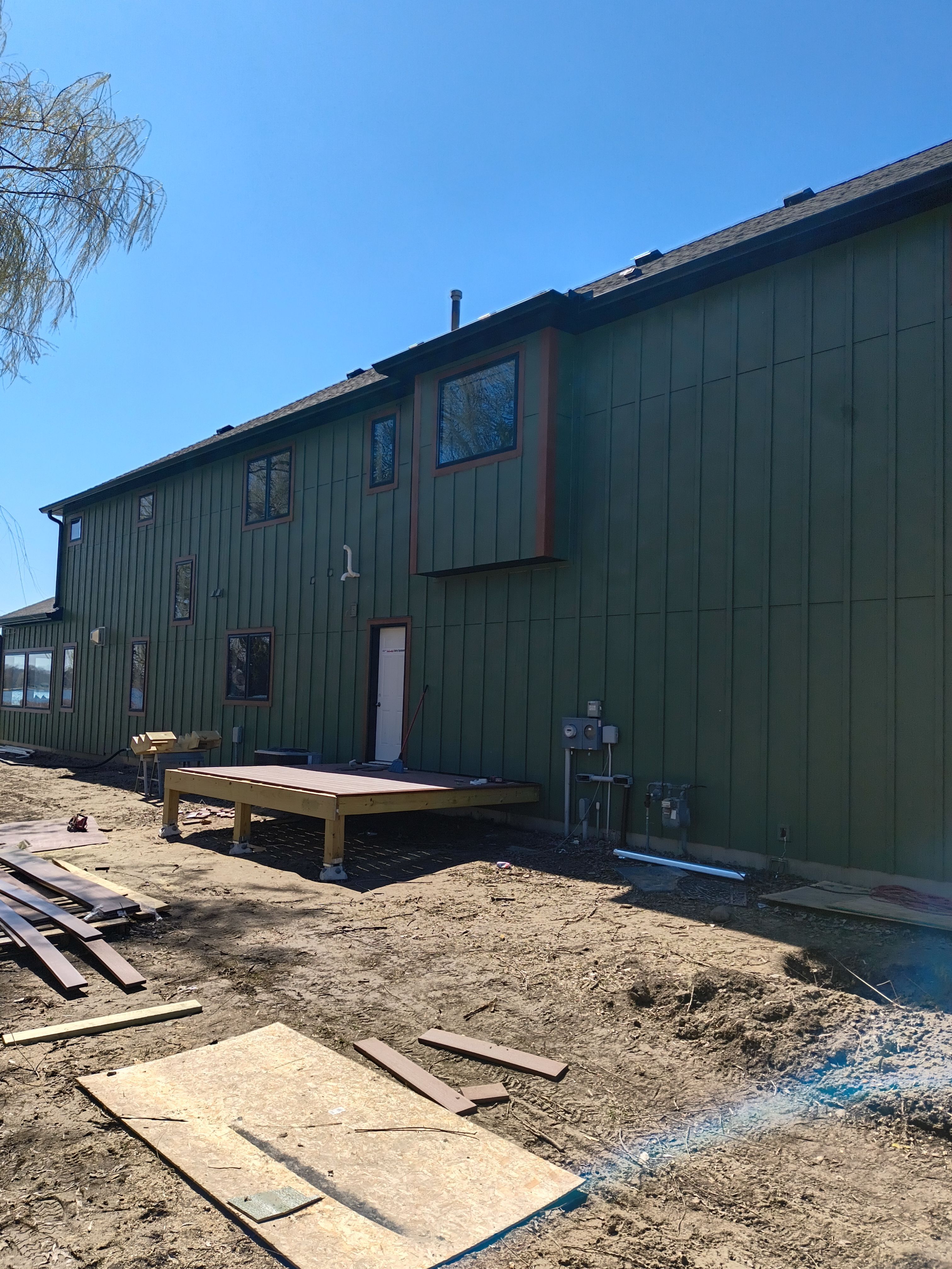 Seamless Gutter Installation in Annandale MN | 6” Black Gutters on Green Home by Next Level Seamless Gutters / Exteriors Inc.