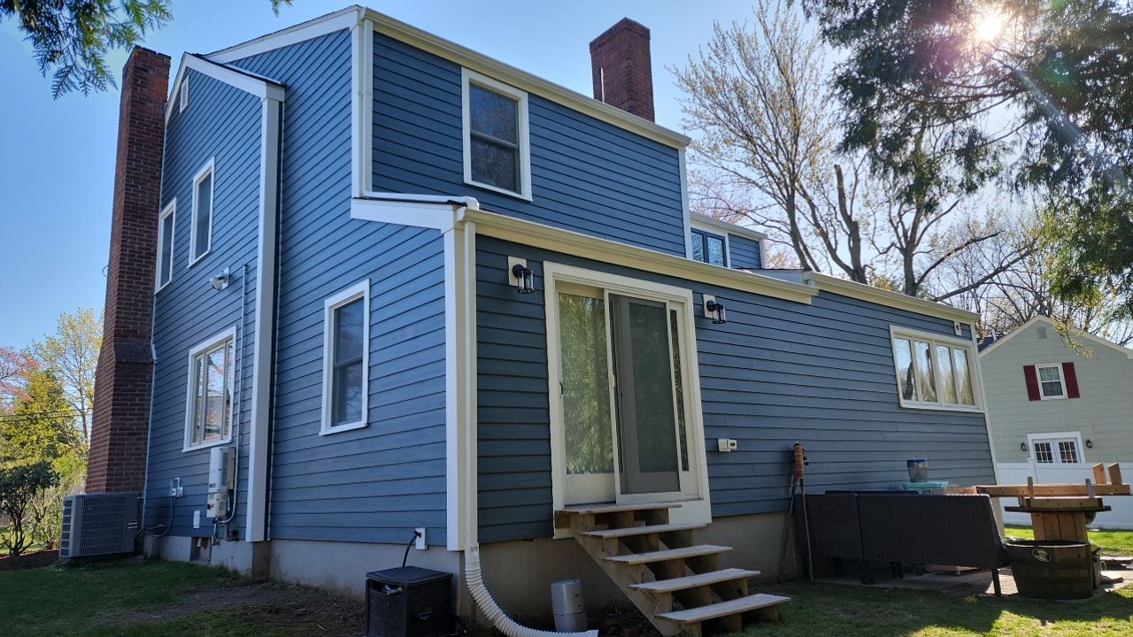 James Hardie siding, new metal roof and couple windows being installed. by UBrothers Construction