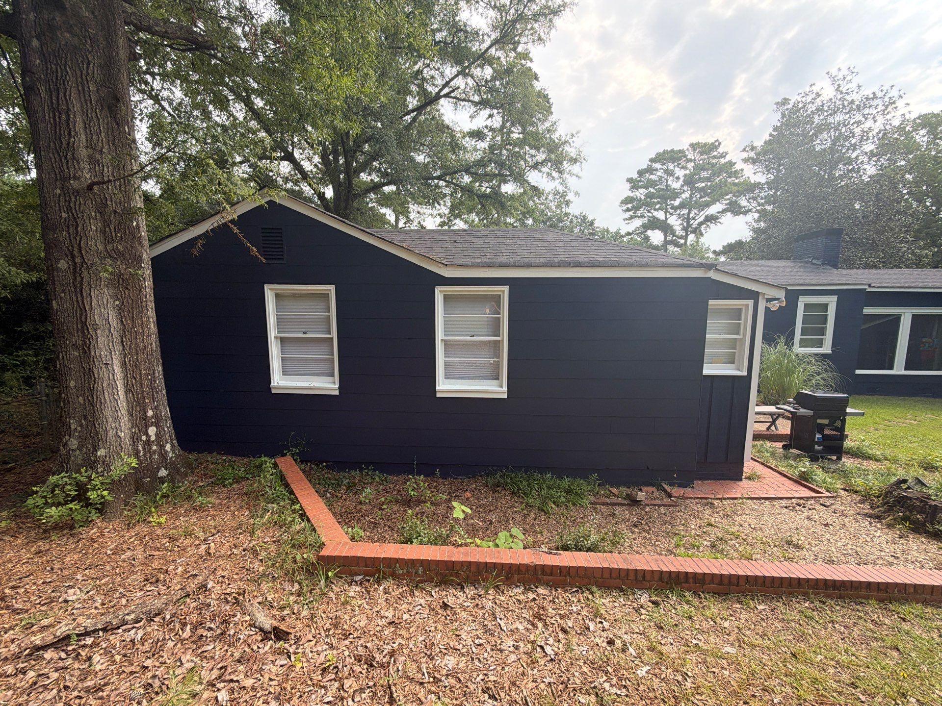 Full Exterior Repaint with Navy Blue and White Trim by Swift Home Renovations
