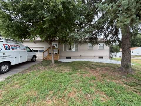 Dark Blue Exterior Painting and Trim Refresh in Sioux Falls by Select Painting, Coatings & Garage Cabinets