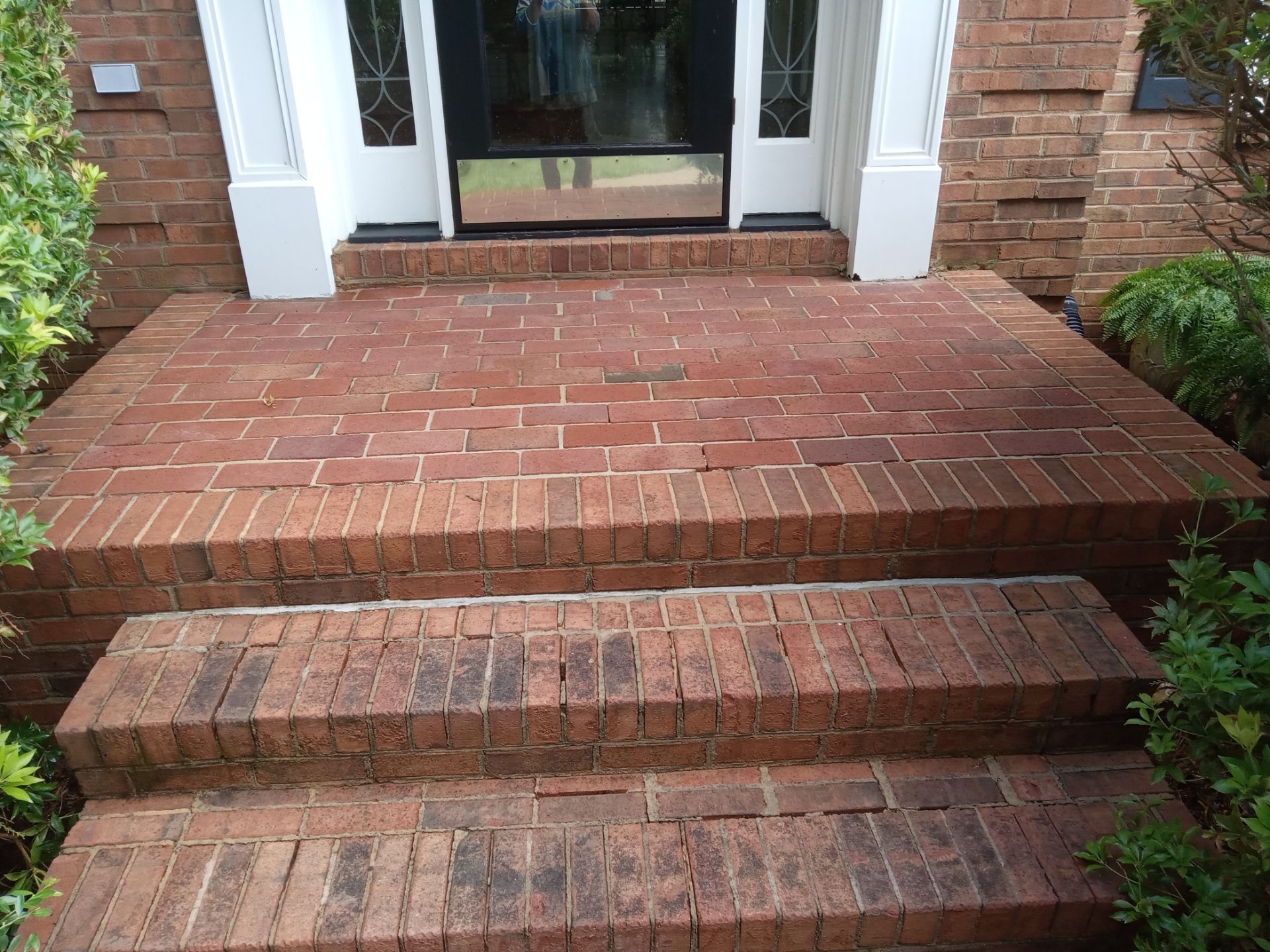 pressure washing brick steps and walkway removing dirt moss and stains restoring appearance